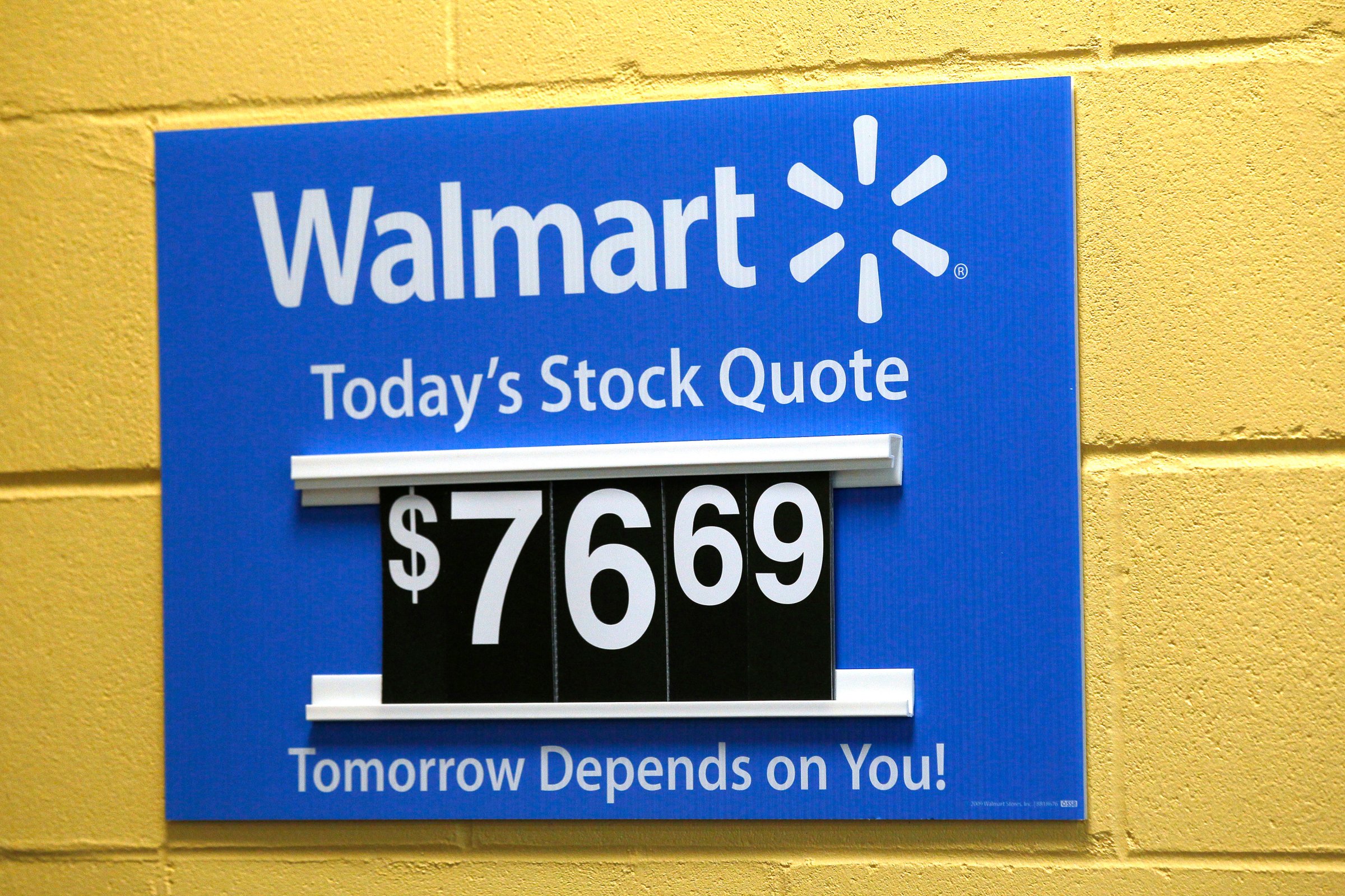 A sign lists the current Walmart stock price at a Walmart Supercenter in Bentonville