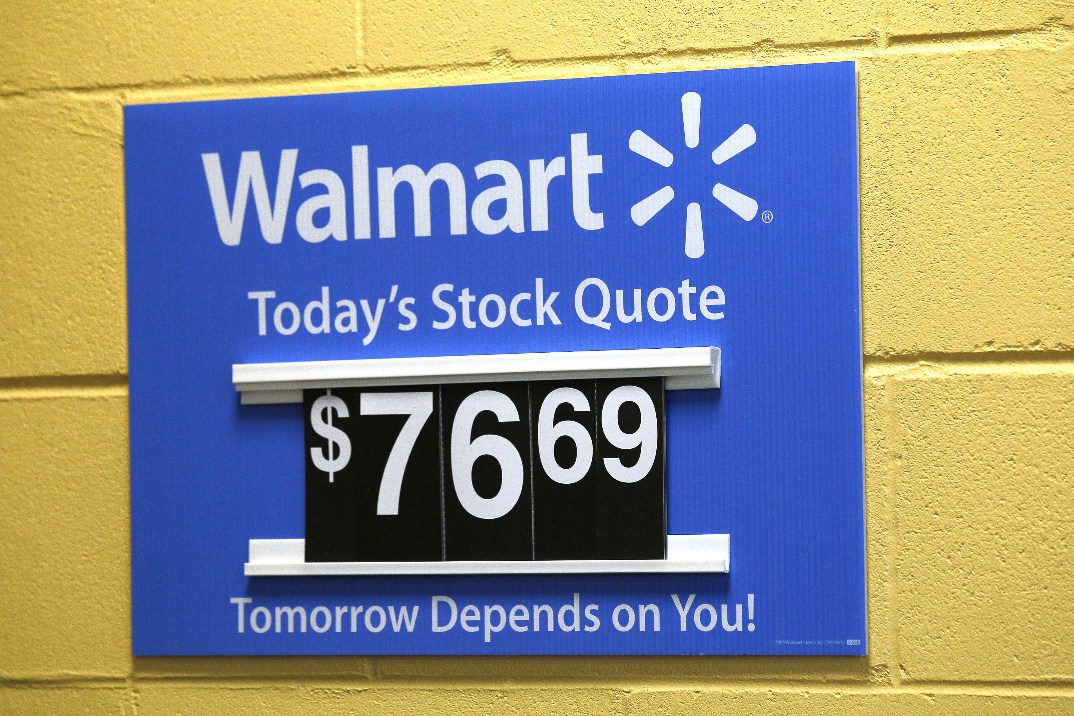 A sign lists the current Walmart stock price at the Walmart Supercenter in Bentonville, Ark., on June 5, 2014 (Rick Wilking — Reuters)