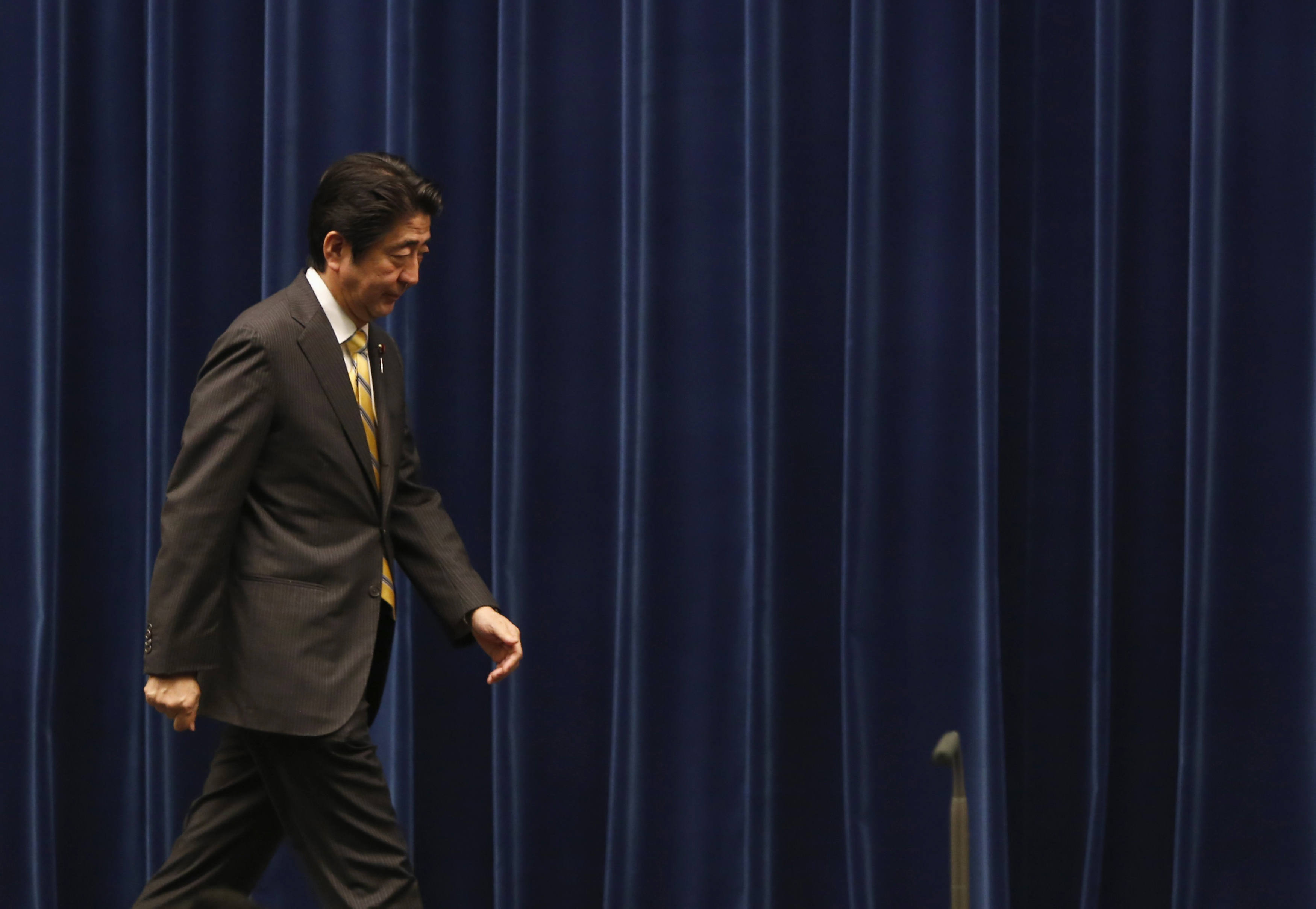Japan's Prime Minister Shinzo Abe leaves a news conference at his official residence in Tokyo on June 24, 2014.  Abe has unveiled a package of measures aimed to boost Japan's long-term economic growth, from phased-in corporate tax cuts to a bigger role for women and foreign workers (Yuya Shino—Reuters)