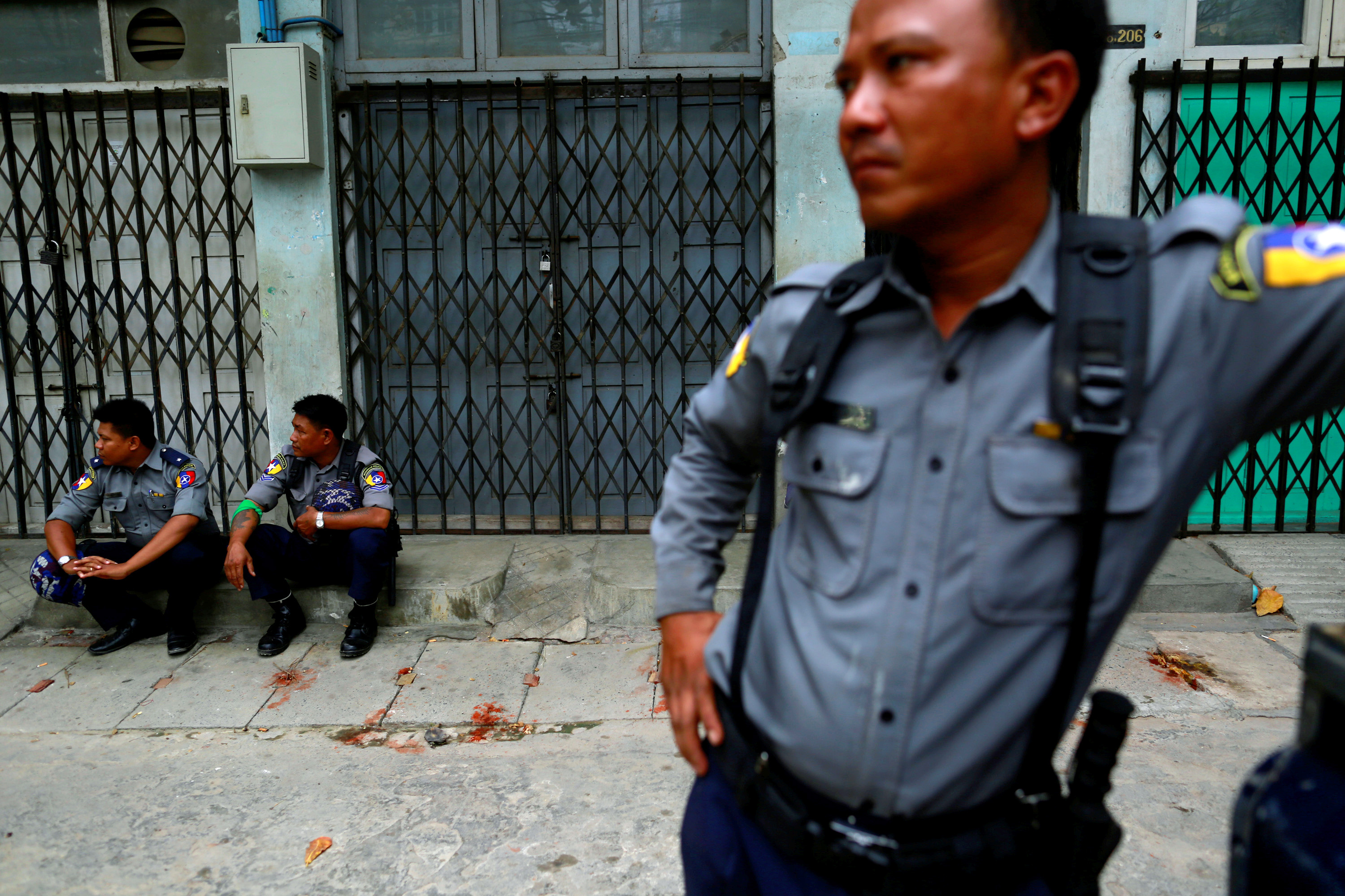Police officers guard a Muslim residential area in Mandalay