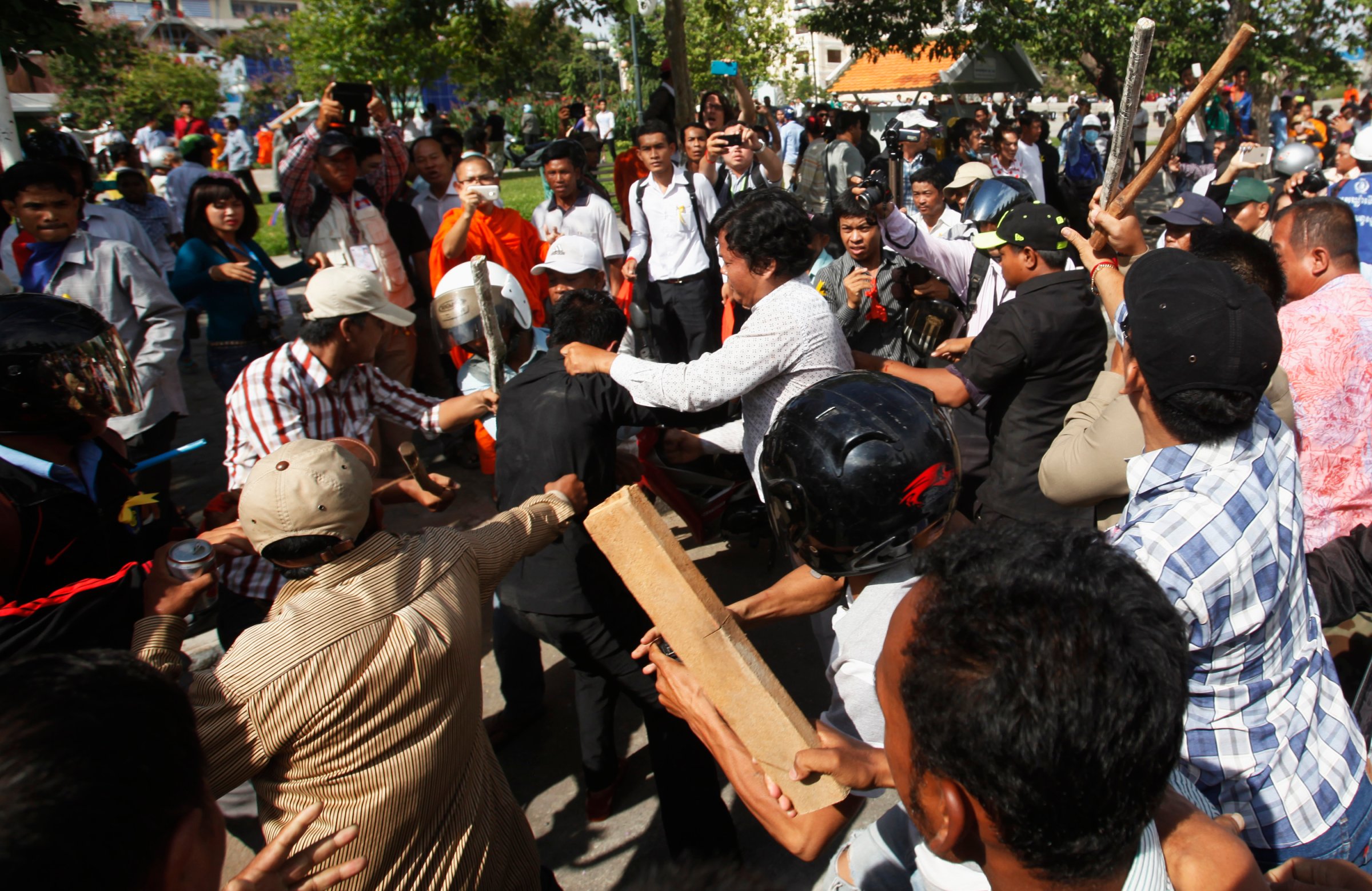 Police officers scuffle with protesters during clashes at Freedom Park in central Phnom Penh