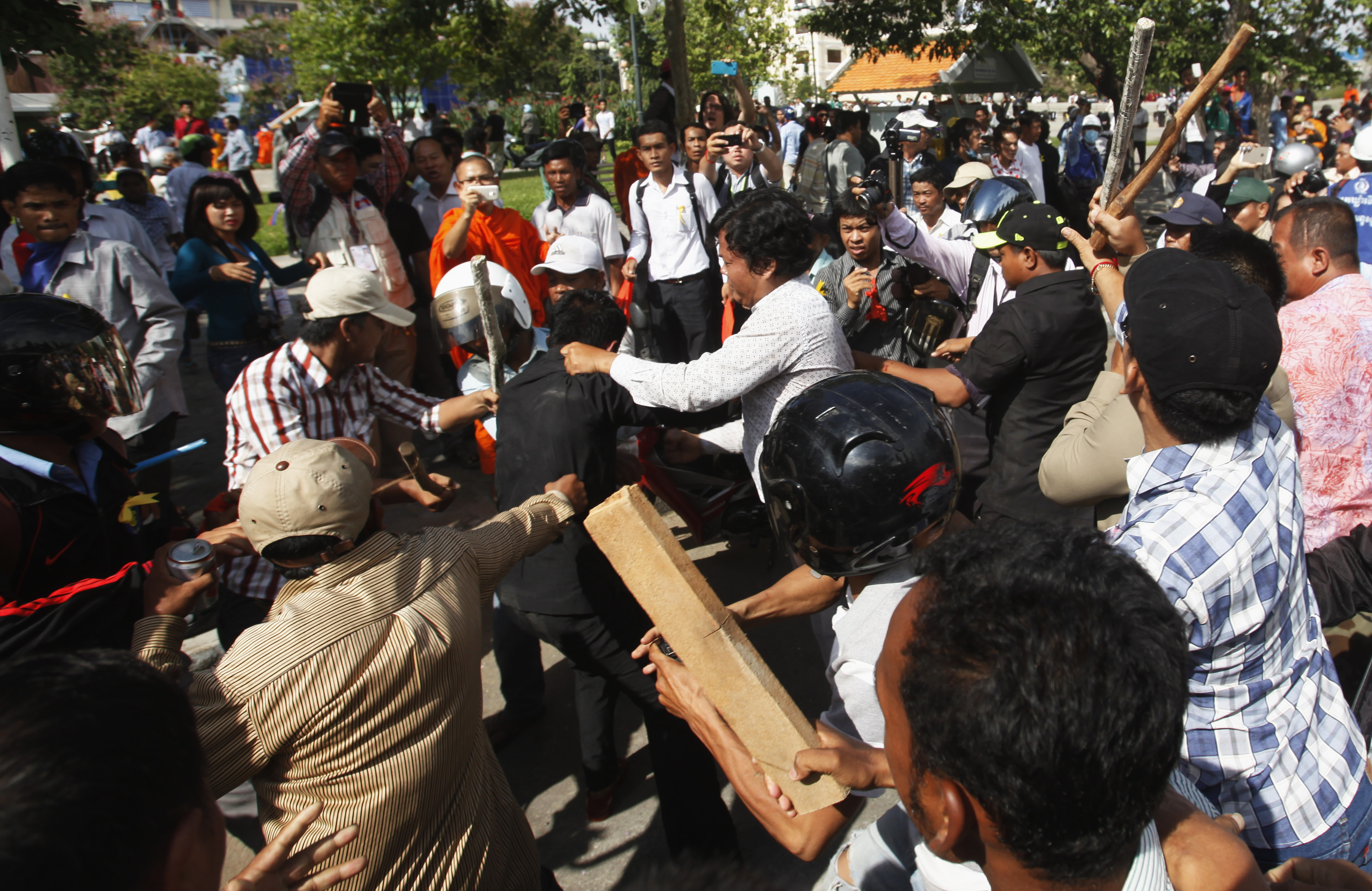 Police officers scuffle with protesters during clashes at Freedom Park in central Phnom Penh July 15, 2014. (Pring Samrang—Reuters)