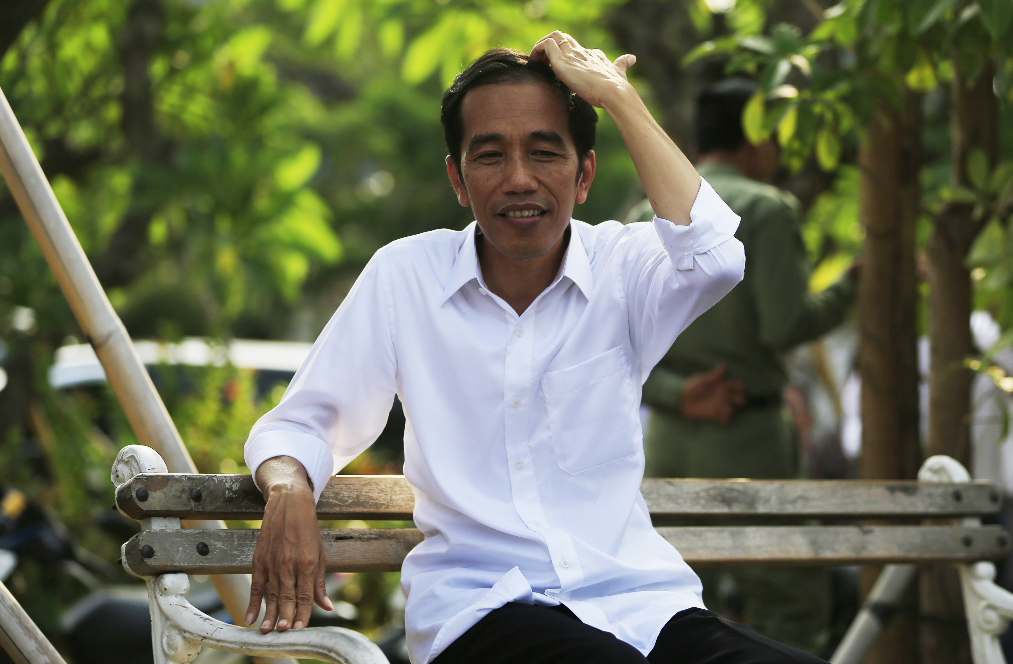 Indonesian presidential candidate Joko "Jokowi" Widodo, now president elect, sits on a bench while waiting for the announcement of election results by the Elections Commission at Waduk Pluit in Jakarta July 22, 2014. (Beawiharta Beawiharta—Reuters)