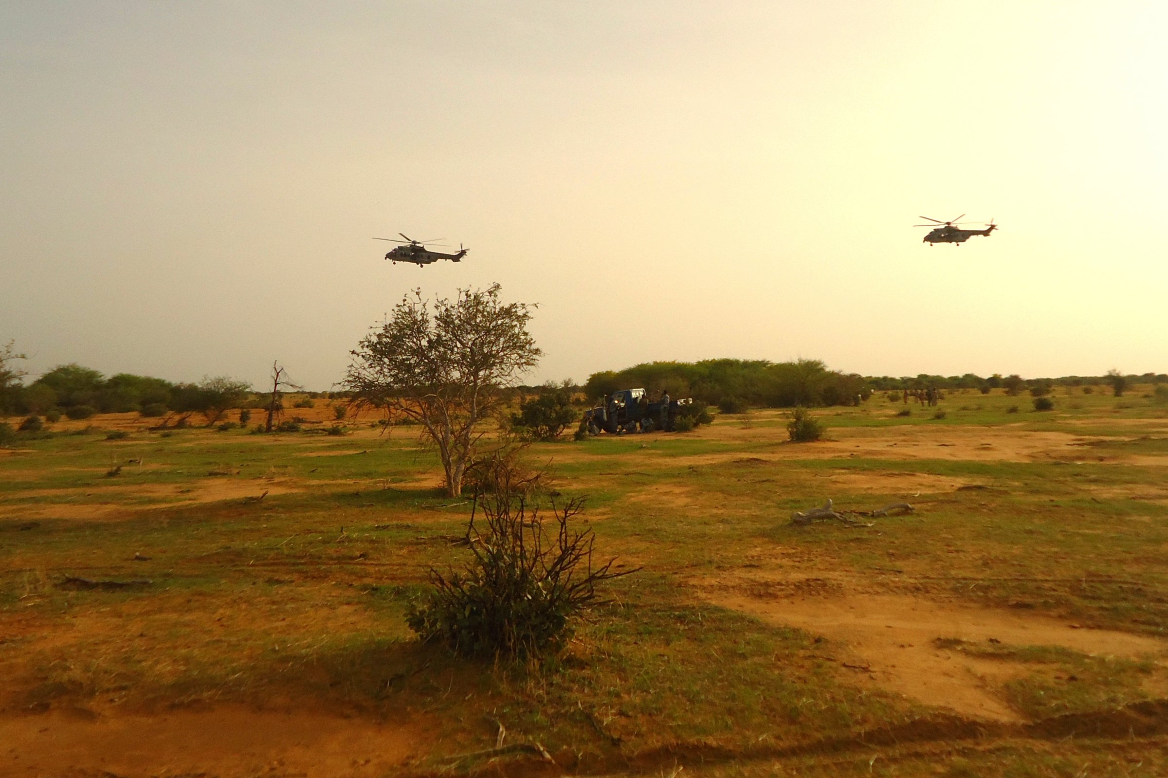 French military helicopters fly above the crash site of Air Algerie flight AH5017 near the northern Mali town of Gossi