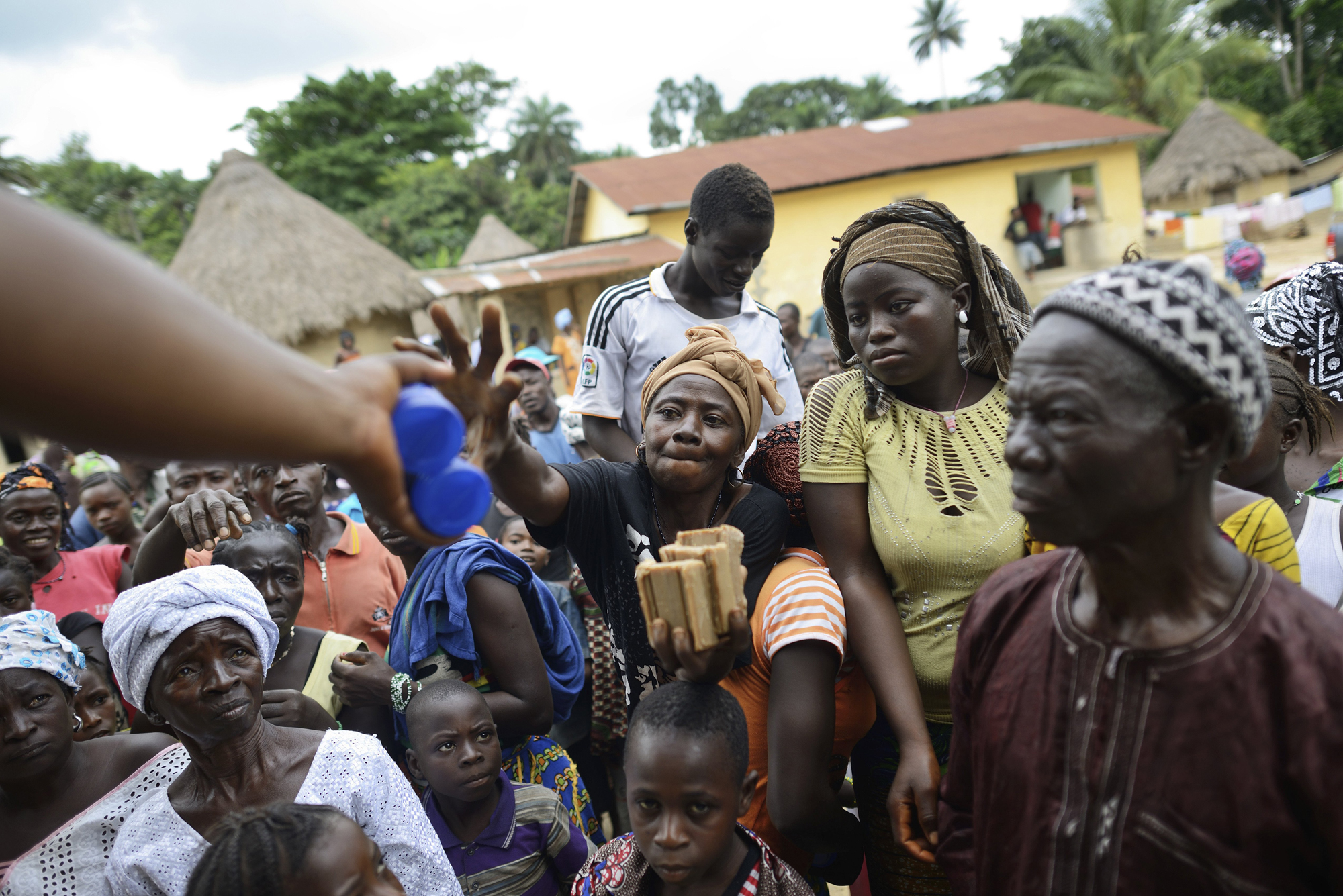 Members of the World Health Organization and Red Cross hand out chlorine and medical soap to combat the spread of the Ebola virus in Bawa, Guinea.