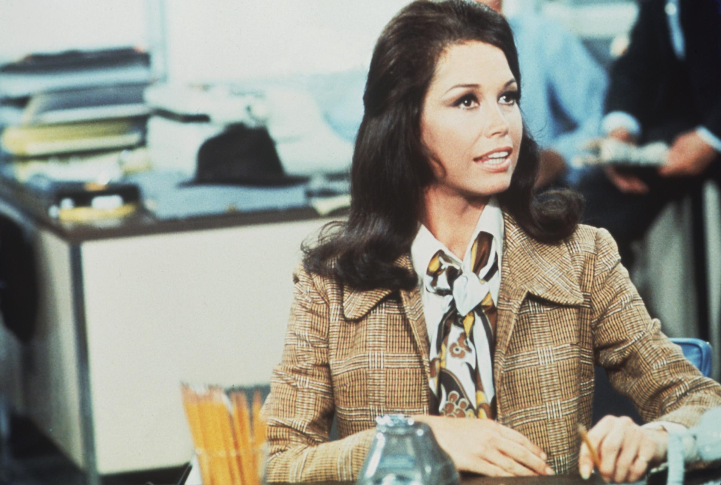 American actress and comedian Mary Tyler Moore (as Mary Richards) sits at a desk in a scene from "The Mary Tyler Moore Show."