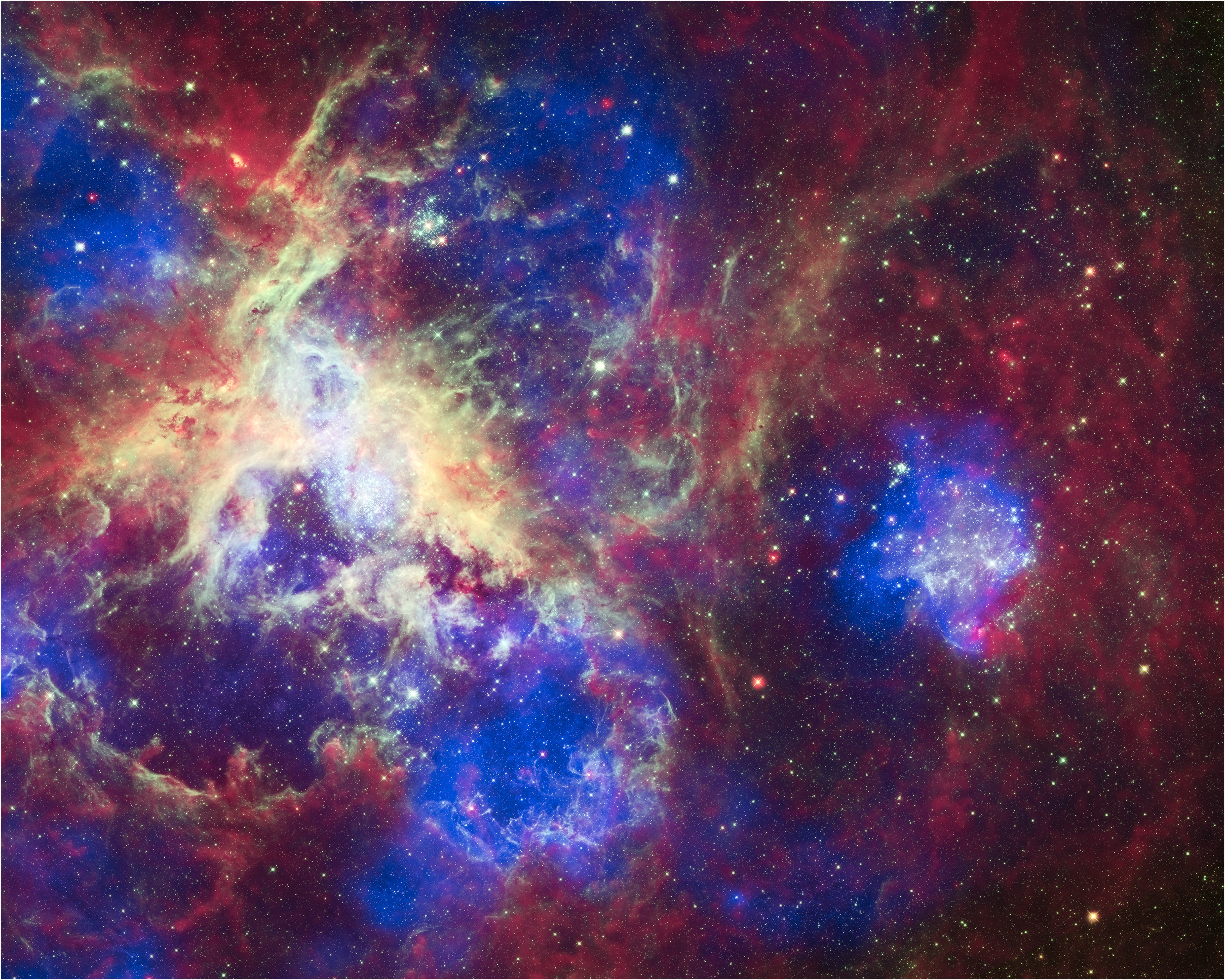 This composite of 30 photos of the Tarantula Nebula, contains data from three telescopes, Chandra (blue), Hubble (green), and Spitzer (red).  Located in the Large Magellanic Cloud, the Tarantula Nebula is one of the largest star-forming regions close to the Milky Way.