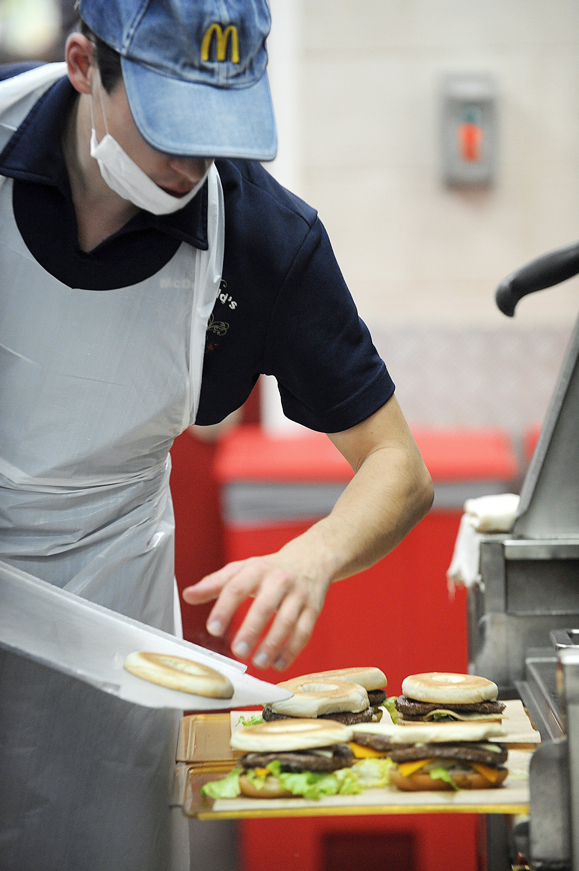 An employee prepares hamburgers at a MacDonalds restaurant.