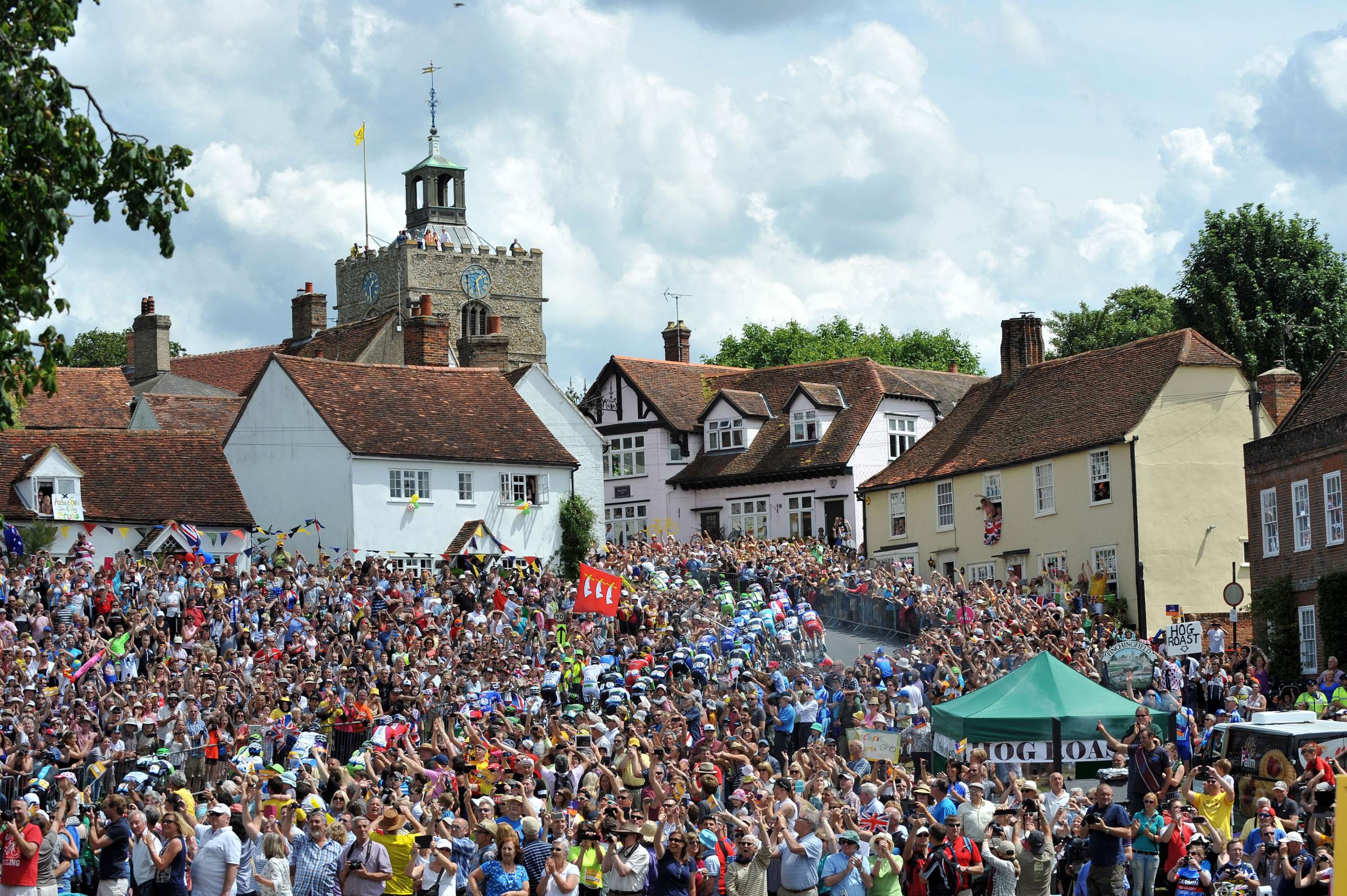 Riders make their way up the short climb in the village of Finchingfield in north Essex during stage three of the Tour de France from Cambridge to London on July 7, 2014.
