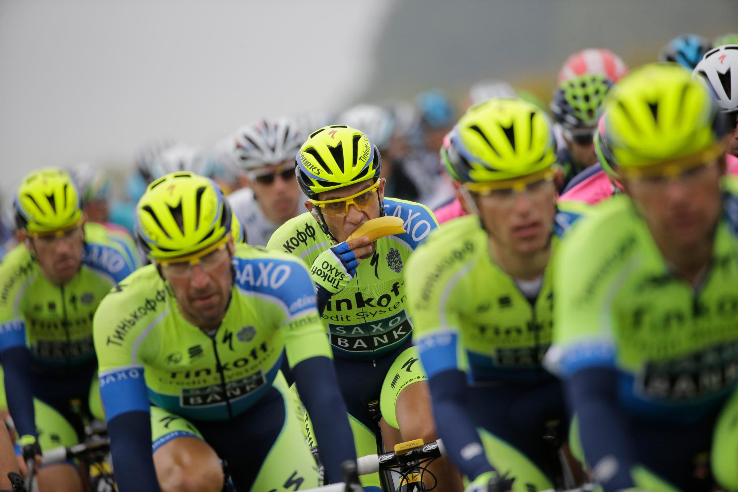 Spain's Alberto Contador eats a banana in as he rides in the pack during the sixth stage of the Tour de France cycling race over 194 kilometers (120.5 miles) with start in Arras and finish in Reims, France on July 10, 2014.