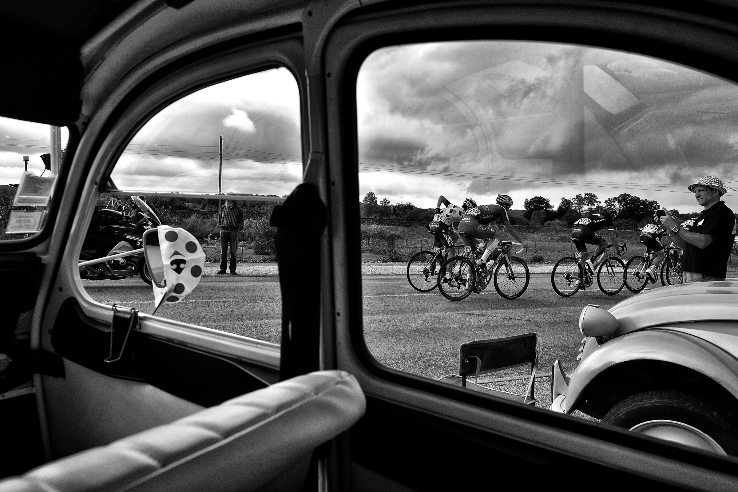 Cyclists riding is seen through a windscreen during the 161 km eighth stage of the 101st edition of the Tour de France cycling race on July 12, 2014 between Tomblaine and Gerardmer La Mauselaine, France.