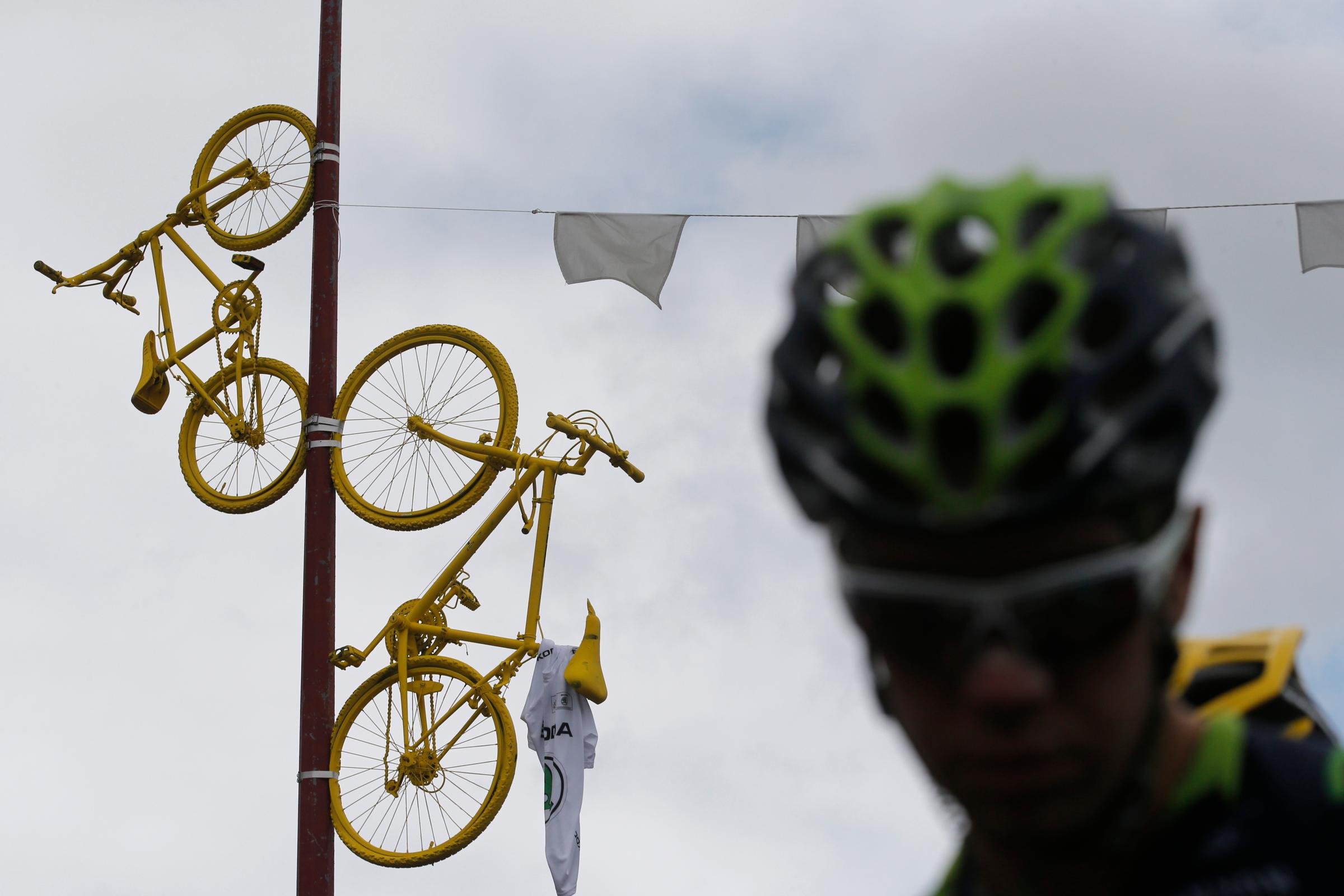 Decorated bicycles hang from a lamppost as riders arrive for the start of the ninth stage of the Tour de France cycling race over 170 kilometers (105.6 miles) with start in Gerardmer and finish in Mulhouse, France on July 13, 2014.