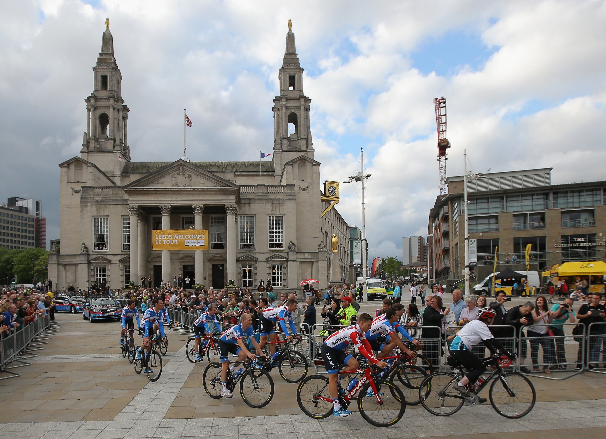 Team Garmin-Sharp is greeted by supporters as they ride through Millenium Square enroute to the Team Presentation prior to the 2014 Le Tour de France on July 3, 2014 in Leeds, United Kingdom.
