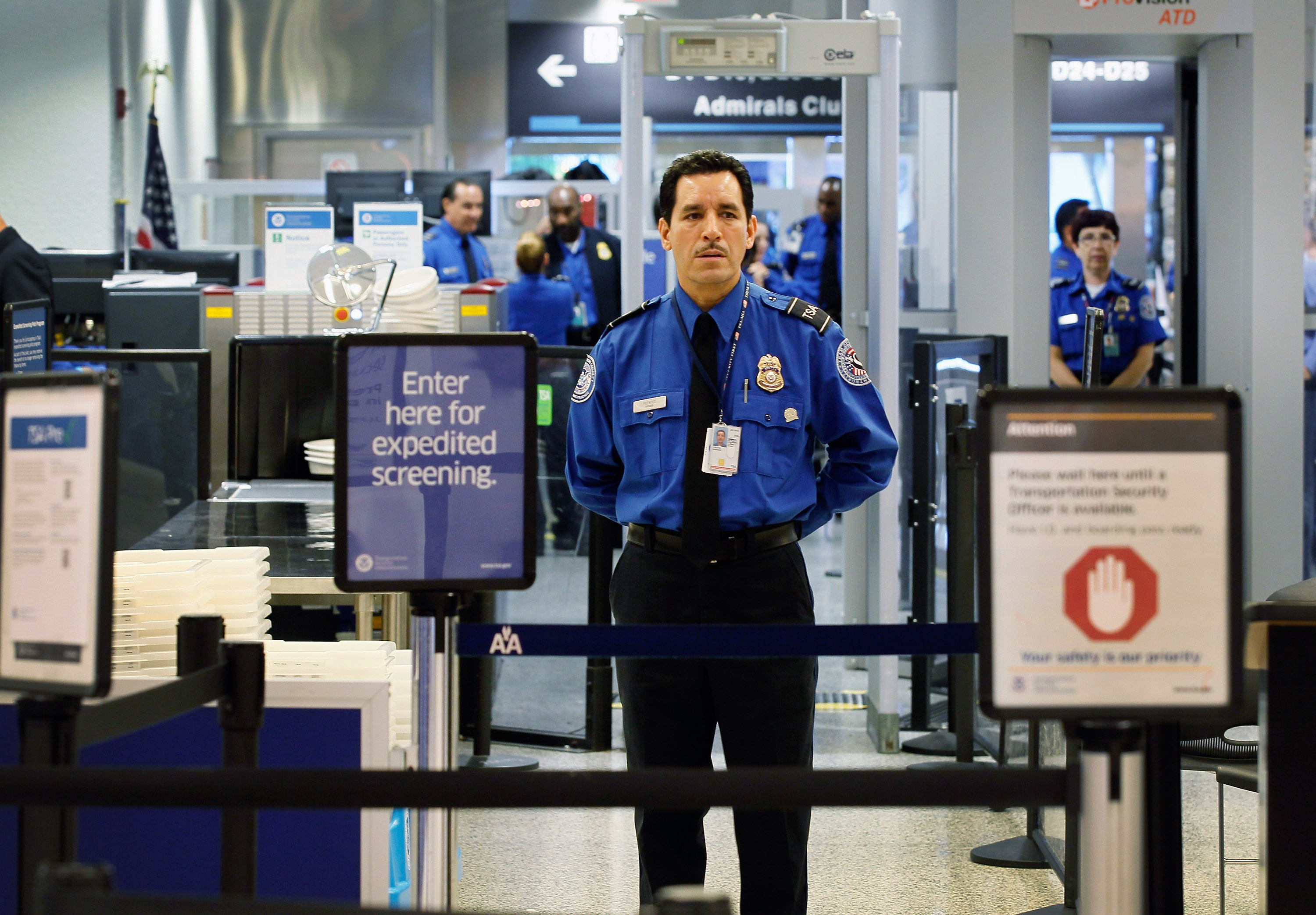 A TSA agent waits for passengers to use the TSA PreCheck lane being implemented by the Transportation Security Administration at Miami International Airport on October 4, 2011 in Miami, Florida. (Joe Raedle—Getty Images)
