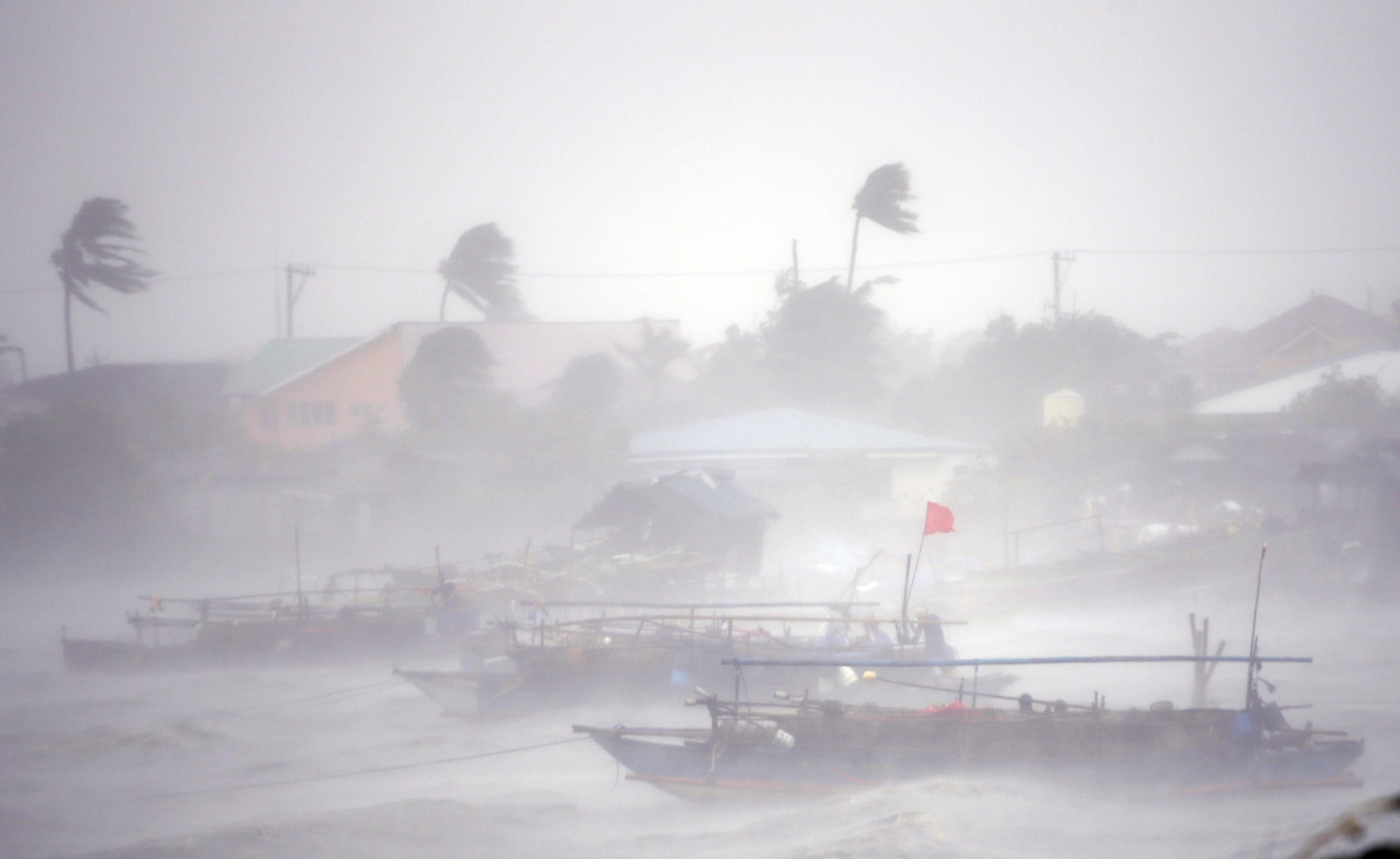 Fishing boats are pictured amid heavy winds and rain brought by Typhoon Rammasun as it hit the town of Imus, Cavite southwest of Manila, July 16, 2014.