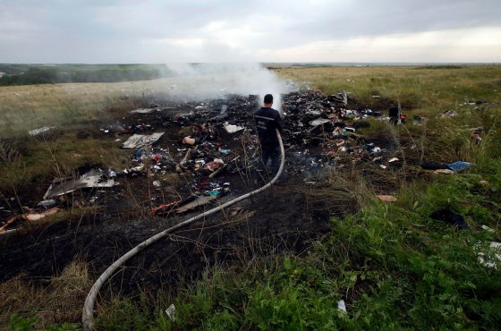 An Emergencies Ministry member works at putting out a fire at the site of a Malaysia Airlines Boeing 777 plane crash in the settlement of Grabovo in the Donetsk region, July 17, 2014.