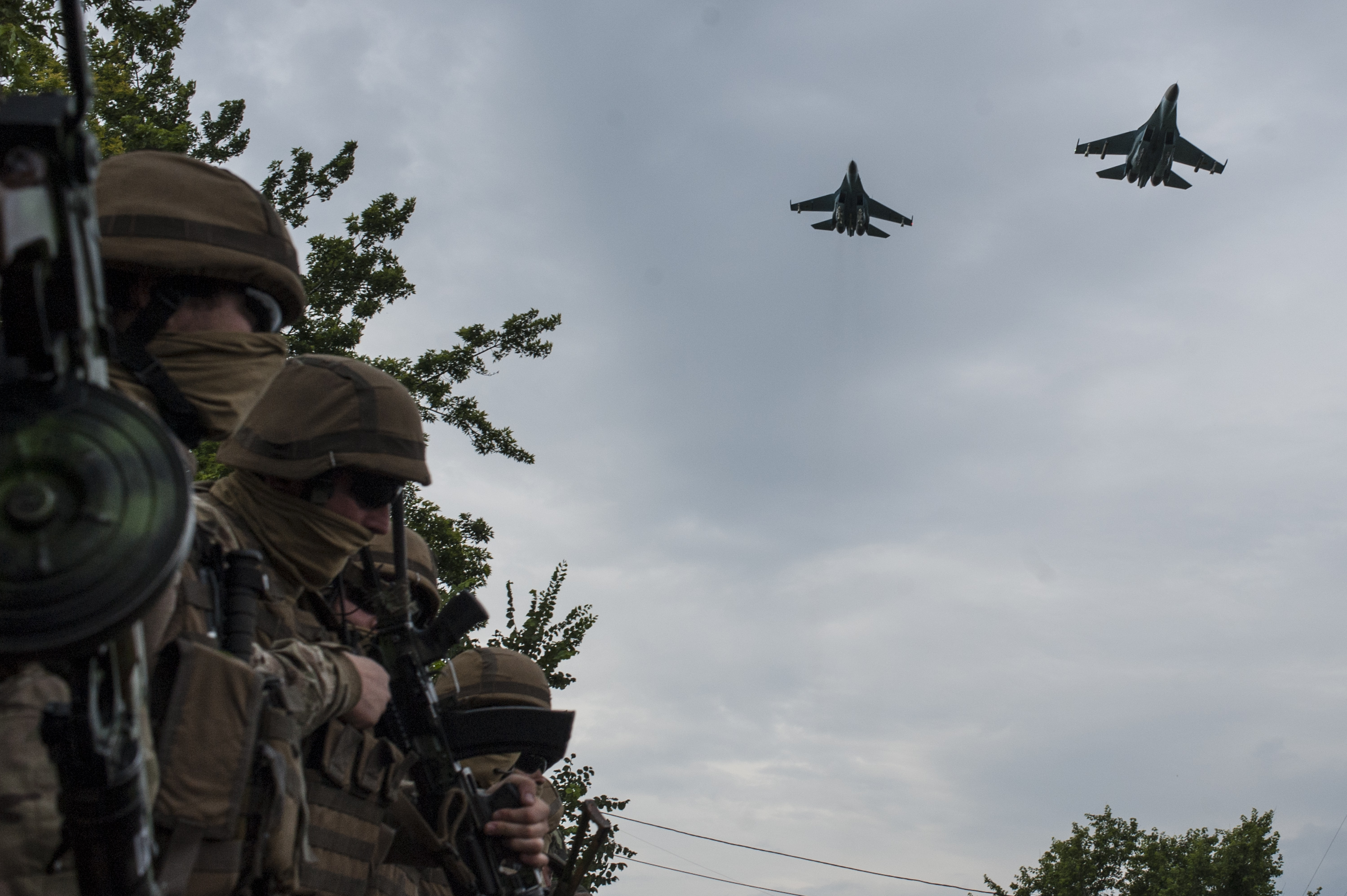 Ukrainian Army jets fly over the Ukrainian government military base while troops wait for Ukrainian President Petro Poroshenko's visit in Devhenke village, Kharkiv region, eastern Ukraine on July 8, 2014. (Evgeniy Maloletka—AP)