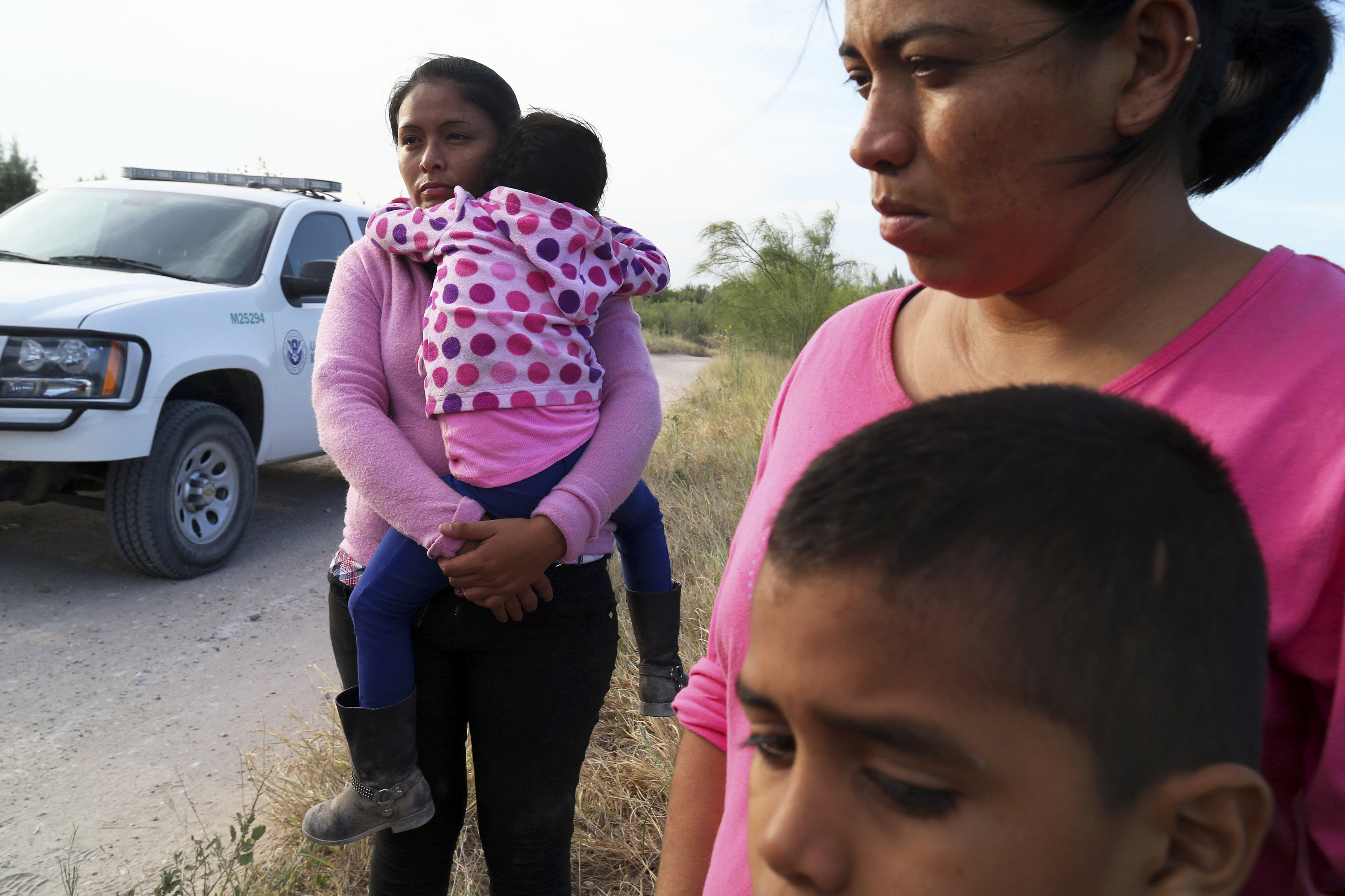 Border Patrol agents process a group of migrants from Honduras and Guatemala, mostly women and children, found walking near the Rio Grande near McAllen, Texas, June 18. (Jennifer Whitney—The New York Times/Redux)