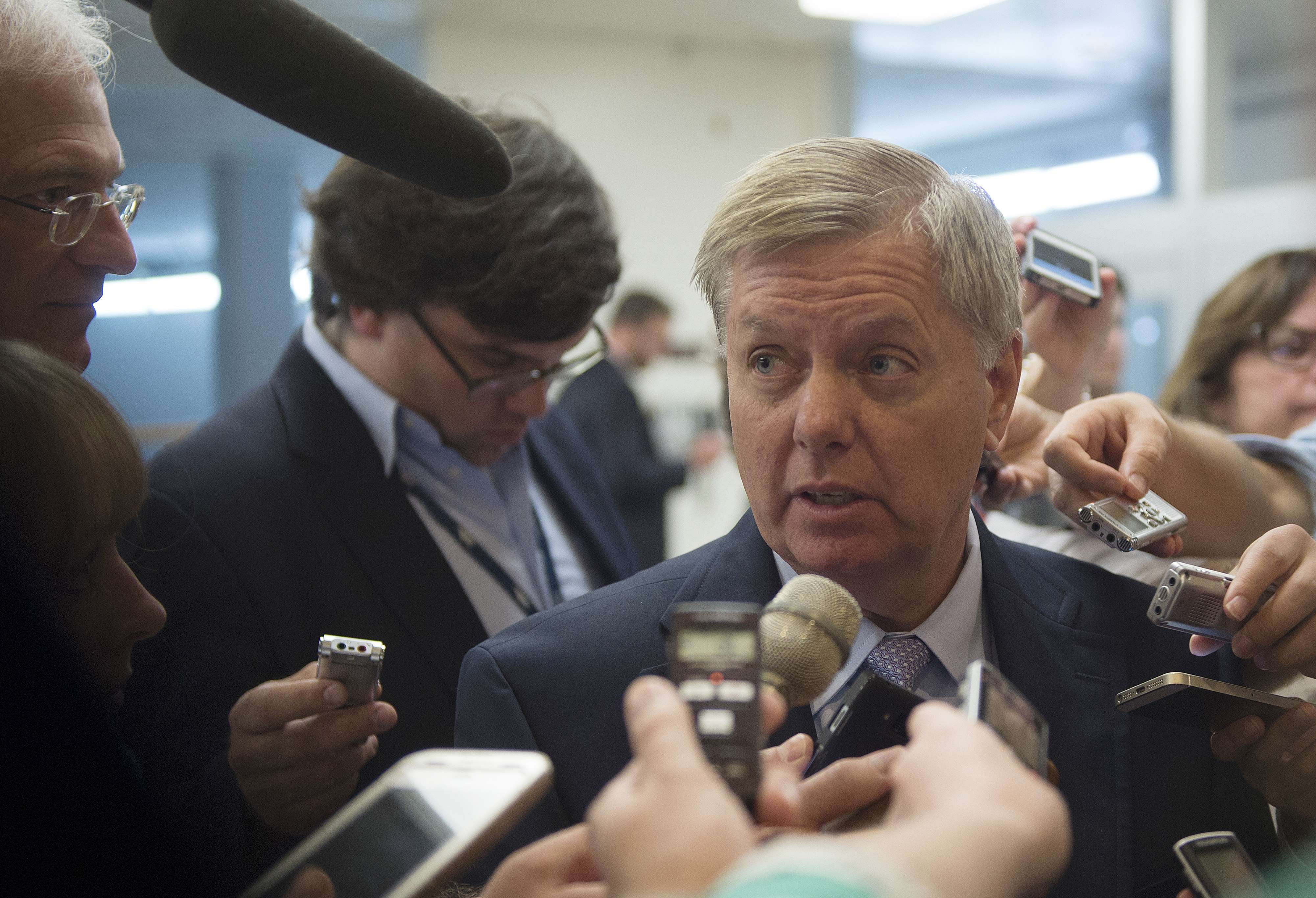 US Senator Lindsey Graham, R-SC, talks to reporters after a closed meeting on Iraq and Afghanistan on Capitol Hill in Washington, DC on July 8, 2014. (Jim Watson—AFP/Getty Images)