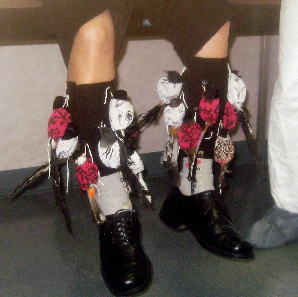 This undated photo provided by the Department of Justice shows a detained suspect  with songbirds strapped to his legs at Los Angeles International Airport The man was charged on May 5, 2009.