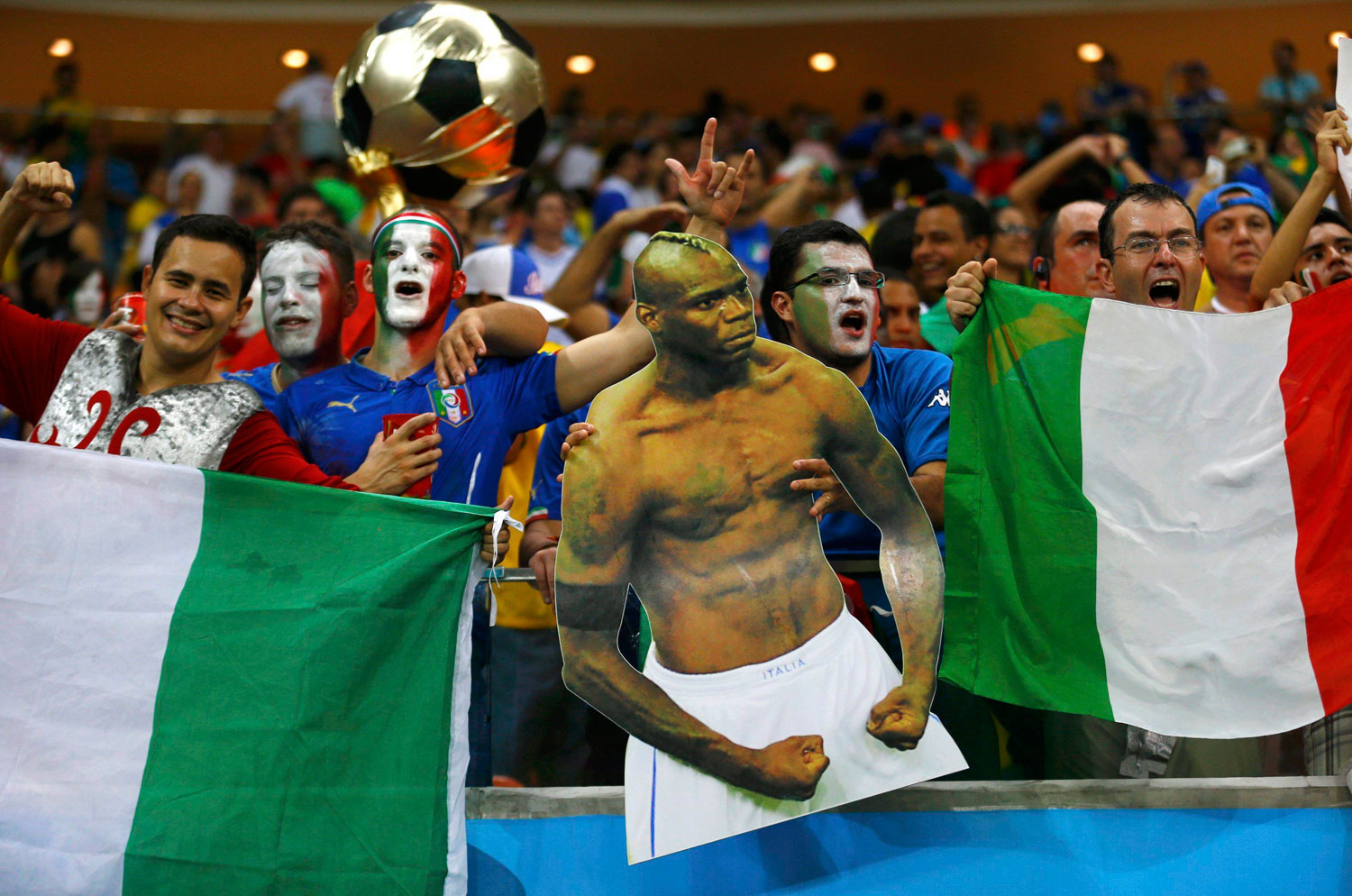 Italy fans hold a cutout of Italy's Mario Balotelli during the match between England and Italy at the Amazonia arena in Manaus, Brazil on June 14, 2014.