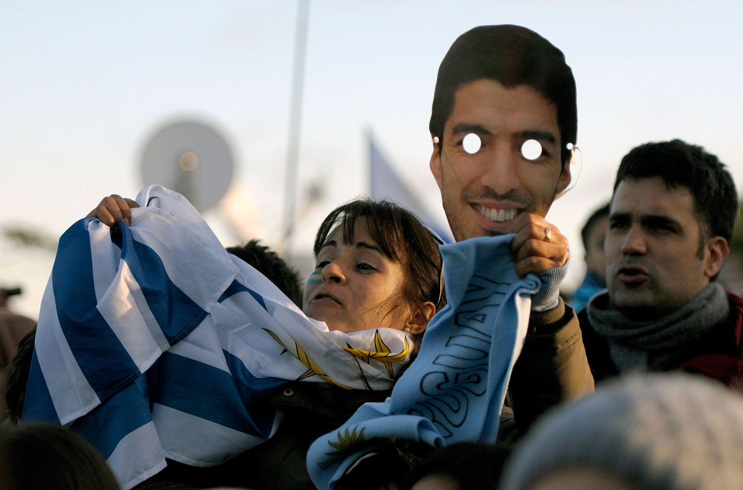 A Uruguay soccer fan holds an image of player Luis Suarez outside Suarez's home where people gather to watch the World Cup via a live telecast of the match between Uruguay and Colombia on the outskirts of Montevideo, Uruguay on June 28, 2014.