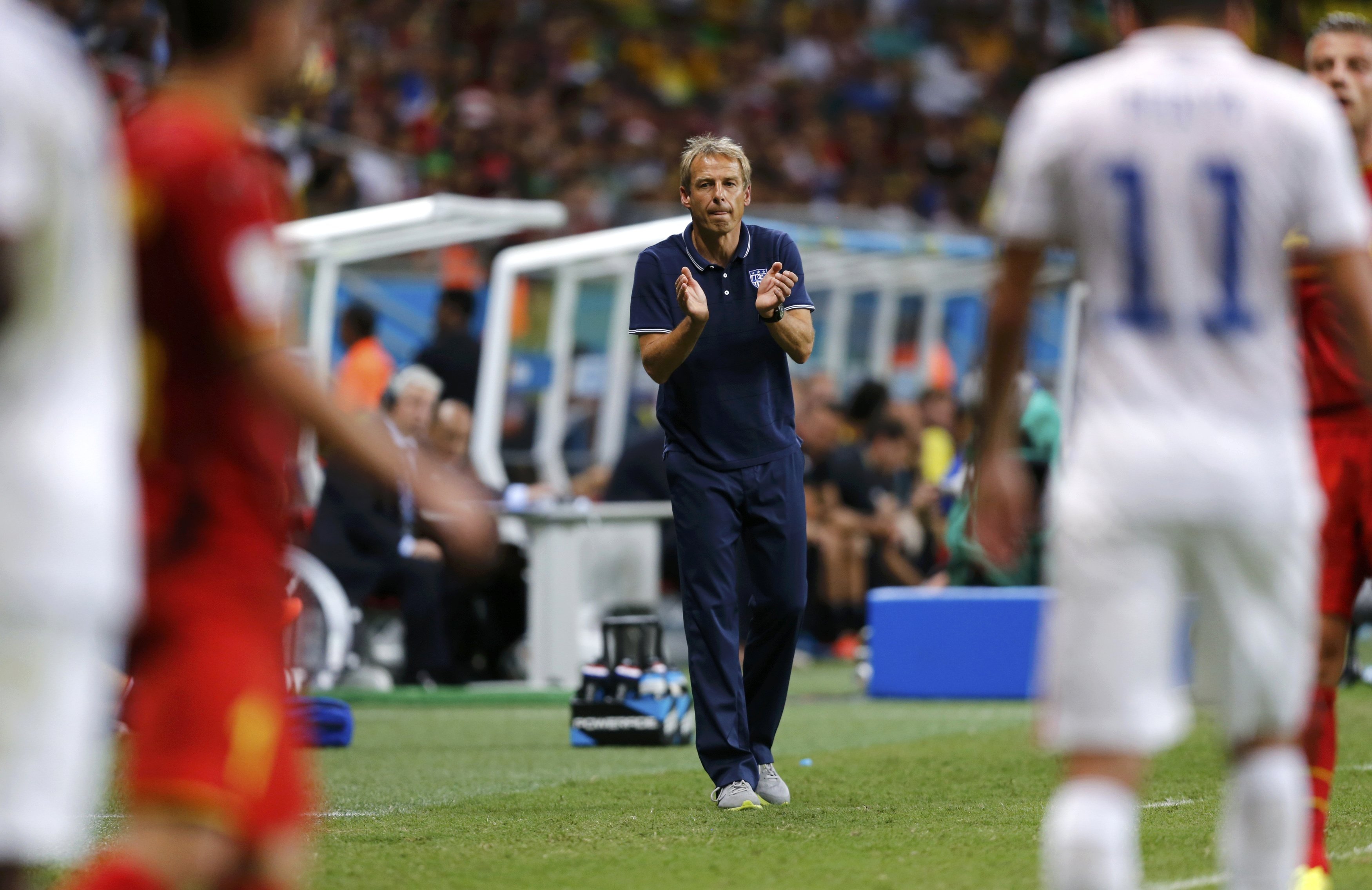 U.S. coach Juergen Klinsmann claps during the game between Belgium and the U.S. at the Fonte Nova arena in Salvador, Brazil on July 1, 2014.
