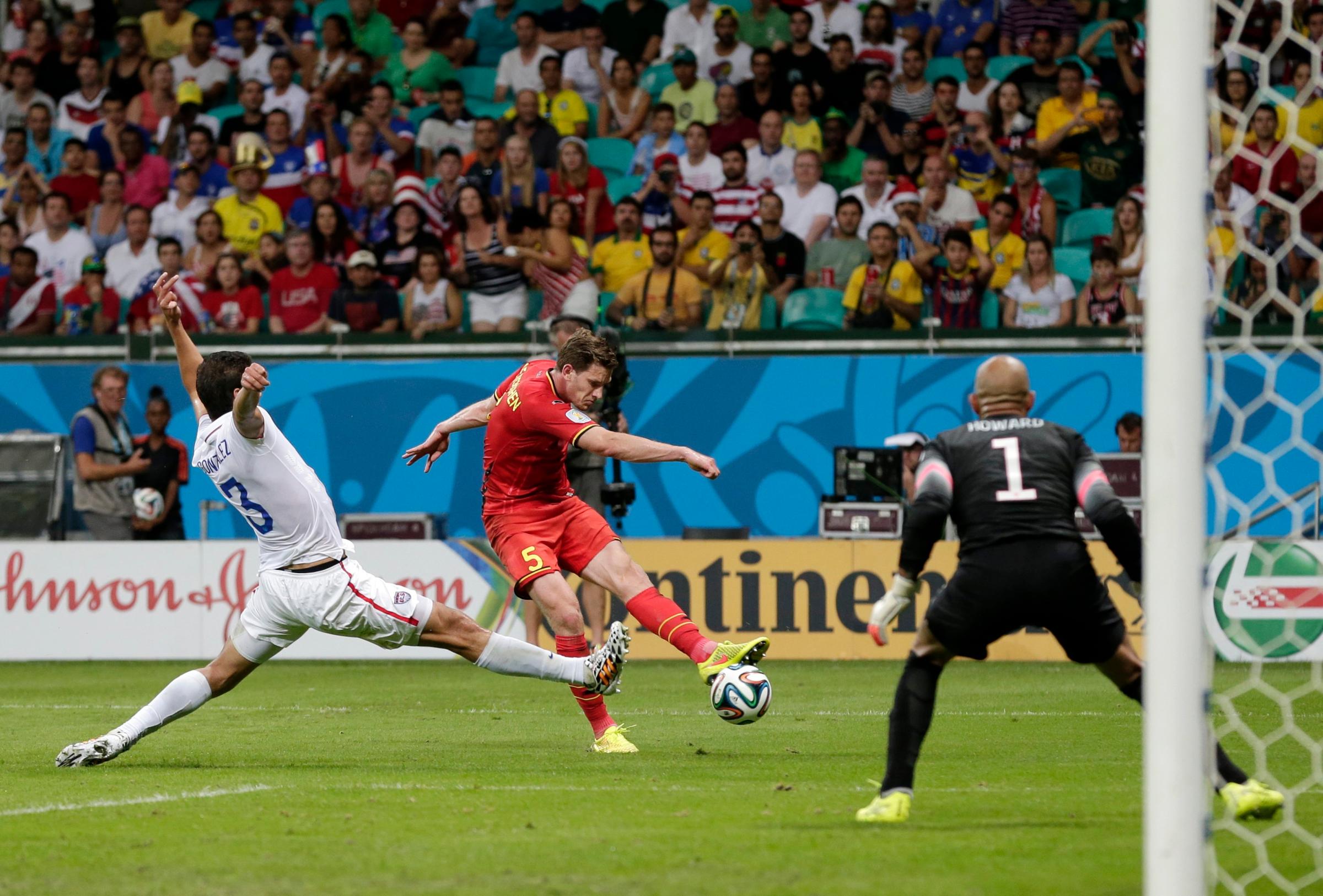 United States' Omar Gonzalez (3) tries to defend as Belgium's Jan Vertonghen gets a shot on United States' goalkeeper Tim Howard during the World Cup round of 16 soccer match between Belgium and the USA at the Arena Fonte Nova in Salvador, Brazil, Tuesday, July 1, 2014.