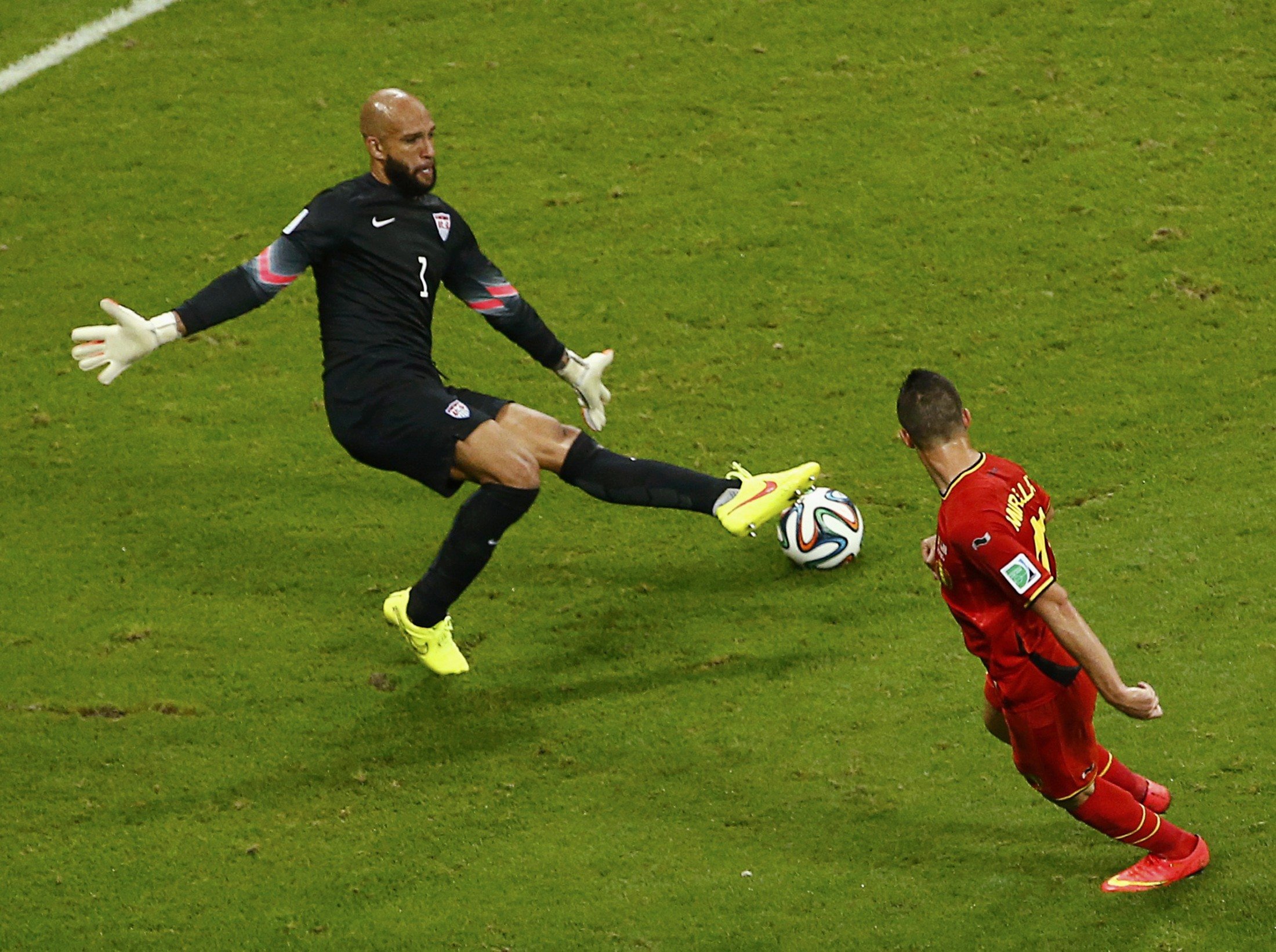 Goalkeeper Tim Howard of the U.S. blocks a shot by Belgium's Kevin Mirallas during their game at the Fonte Nova arena in Salvador, Brazil on July 1, 2014.