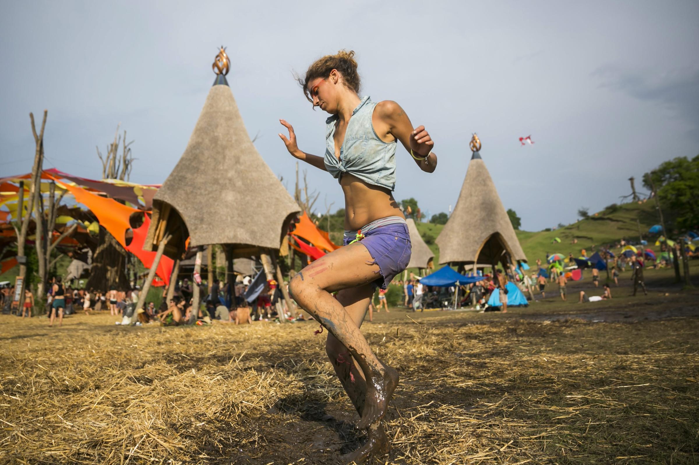 A young woman dances during the 2014 O.Z.O.R.A. Festival, described by organizers as the Psychedelic Tribal Gathering, near the village of Ozora, south of Budapest, Hungary on August 2, 2014.