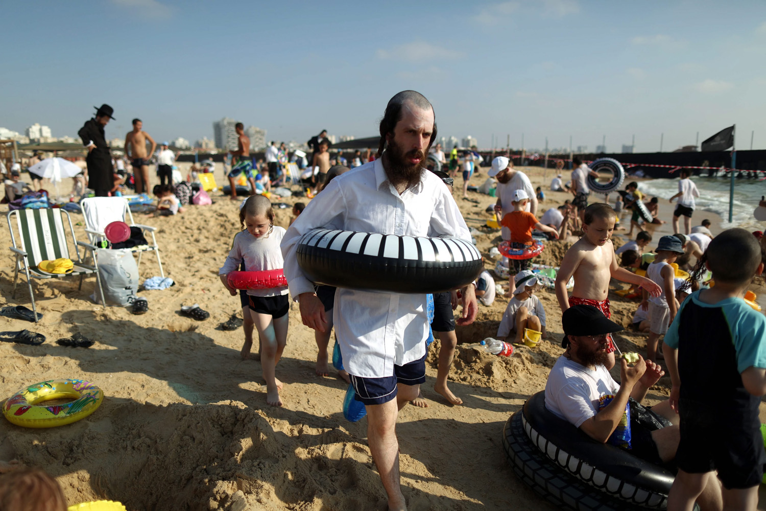 Ultra Orthodox Jews enjoying summer time at the beach with their families in the southern city of Ashdod , Israel on August 13, 2014.