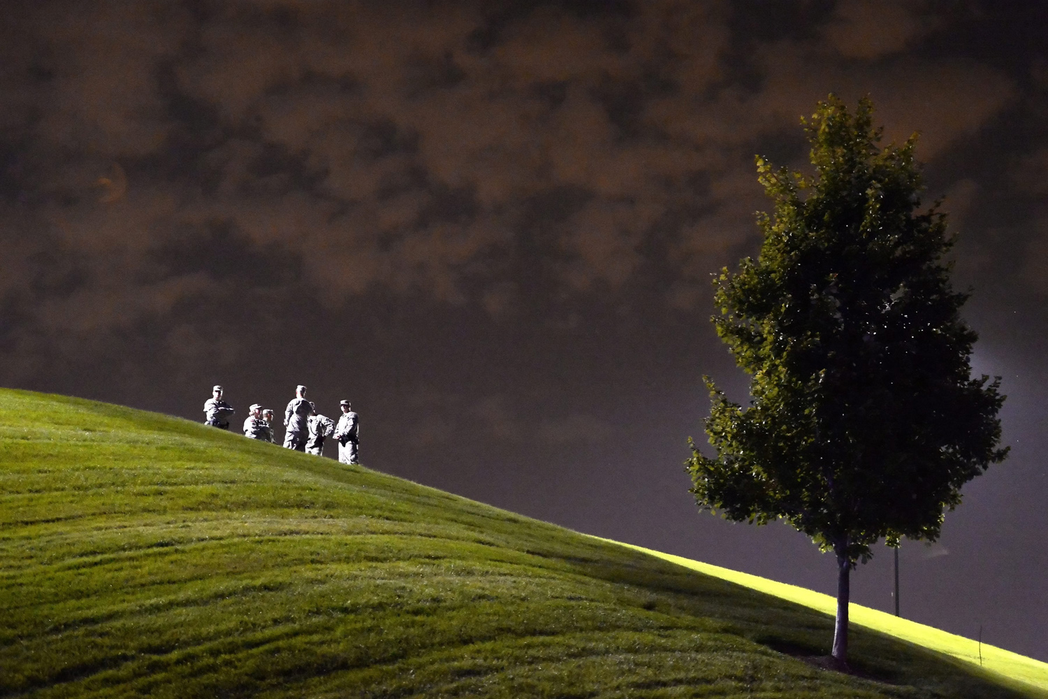 Aug. 21, 2014. National Guard watch from a small hill top a couple blocks away as demonstrators protest the shooting death of Michael Brown in Ferguson, Missouri.
