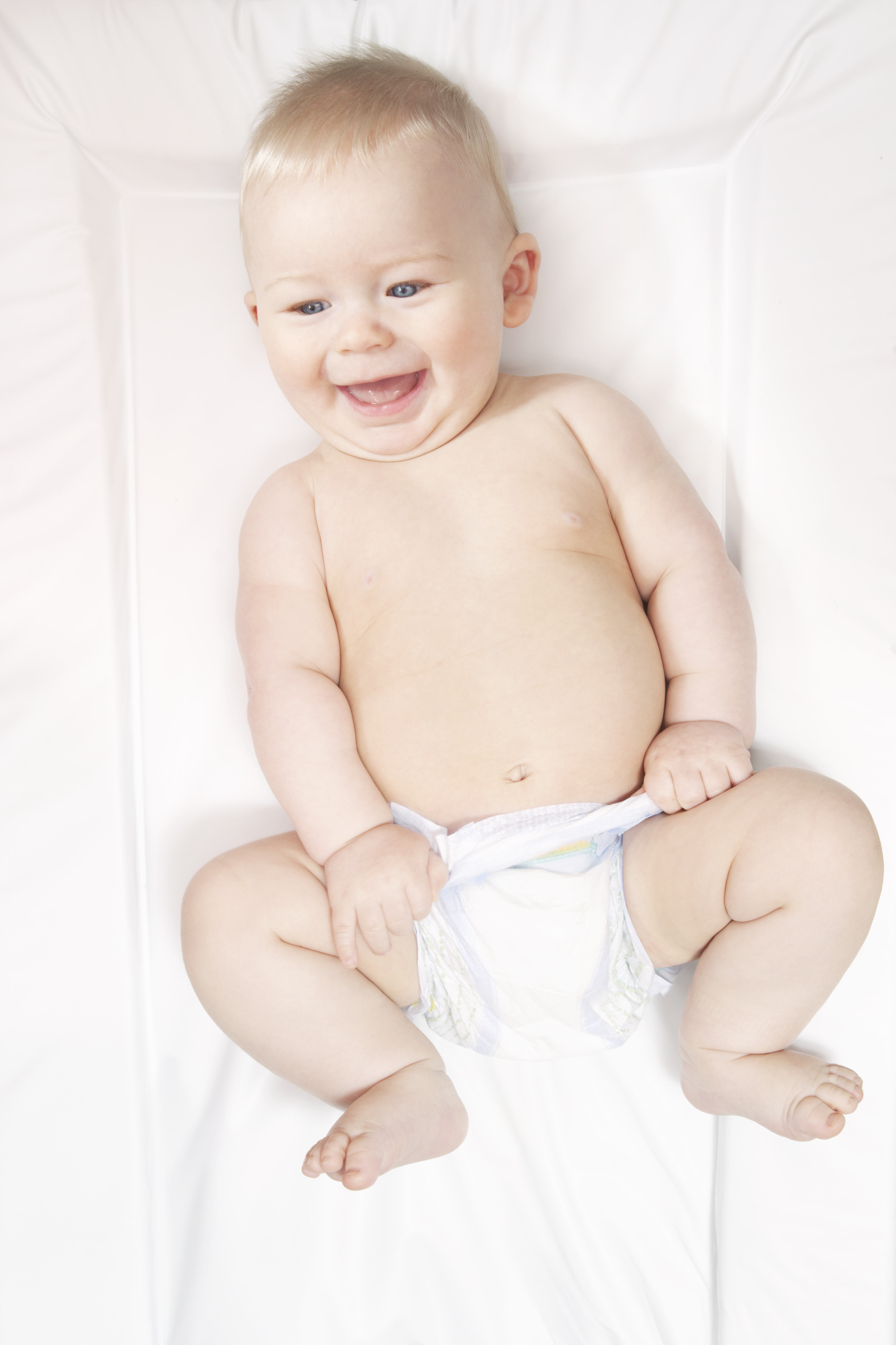 Baby in nappy on changing mat. (Lisa Stirling—Getty Images)