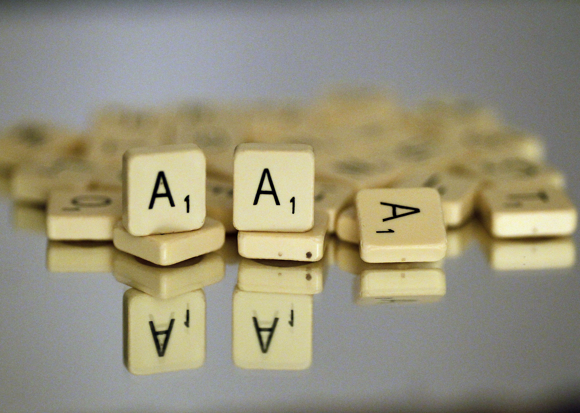 Scrabble "A" lettered tiles are displaye
