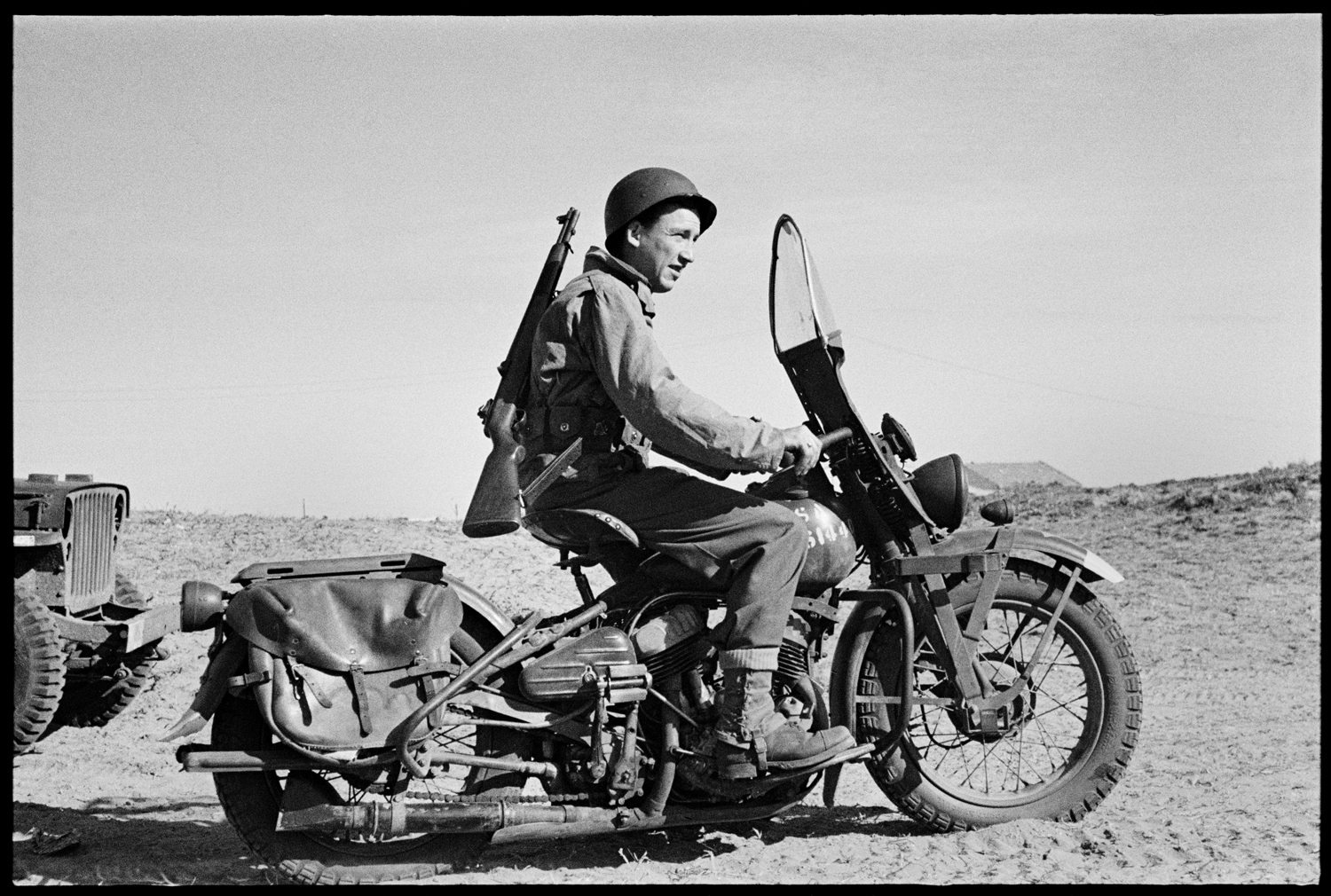 U.S. Army Ranger on motorcycle, Sicily, 1943.