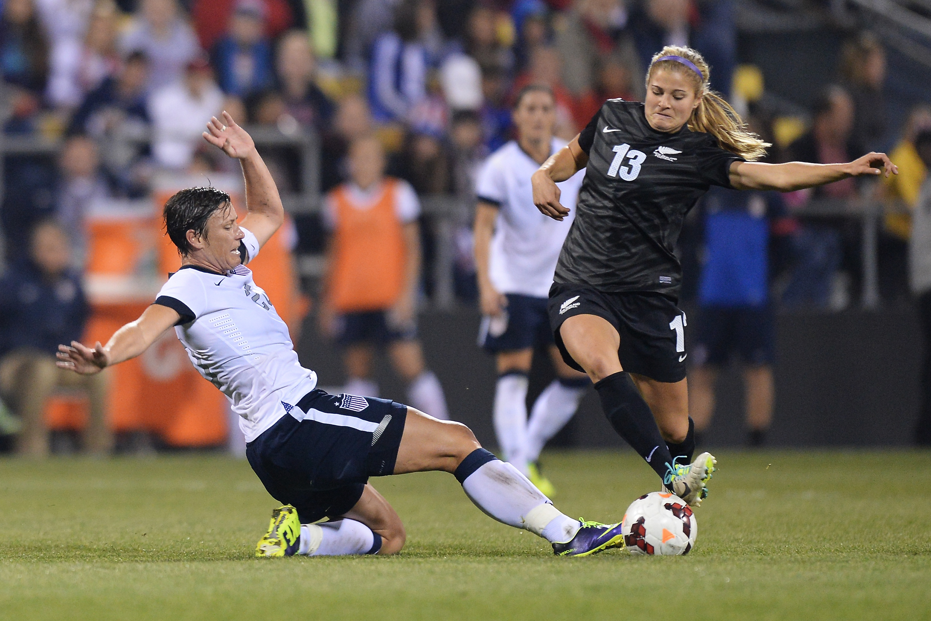 Abby Wambach #20 of the US Women's National Team slides in to attempt to kick the ball away from the control of Rosie White #13 of the New Zealand Women's National Team in the second half at Columbus Crew Stadium on October 30, 2013 in Columbus, Ohio. (Jamie Sabau&mdash;Getty Images)