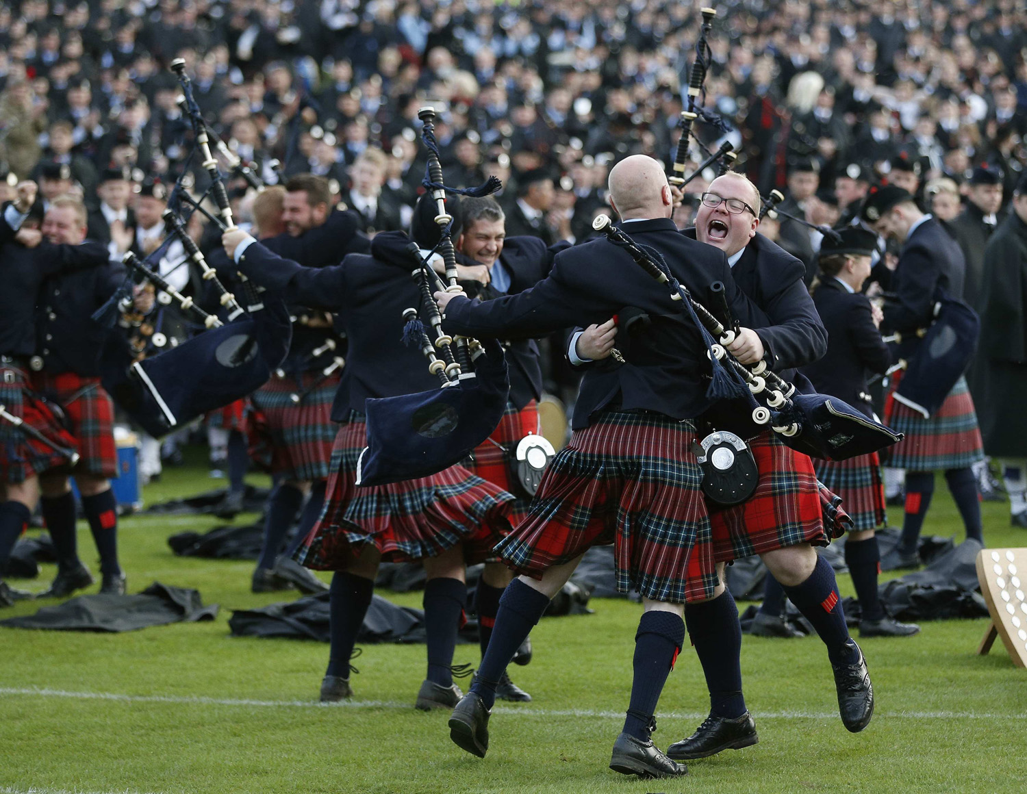 Members of the Field Marshall Montgomery Pipe Band react to winning the annual World Pipe Band Championships at Glasgow Green, Scotland on Aug. 16, 2014.