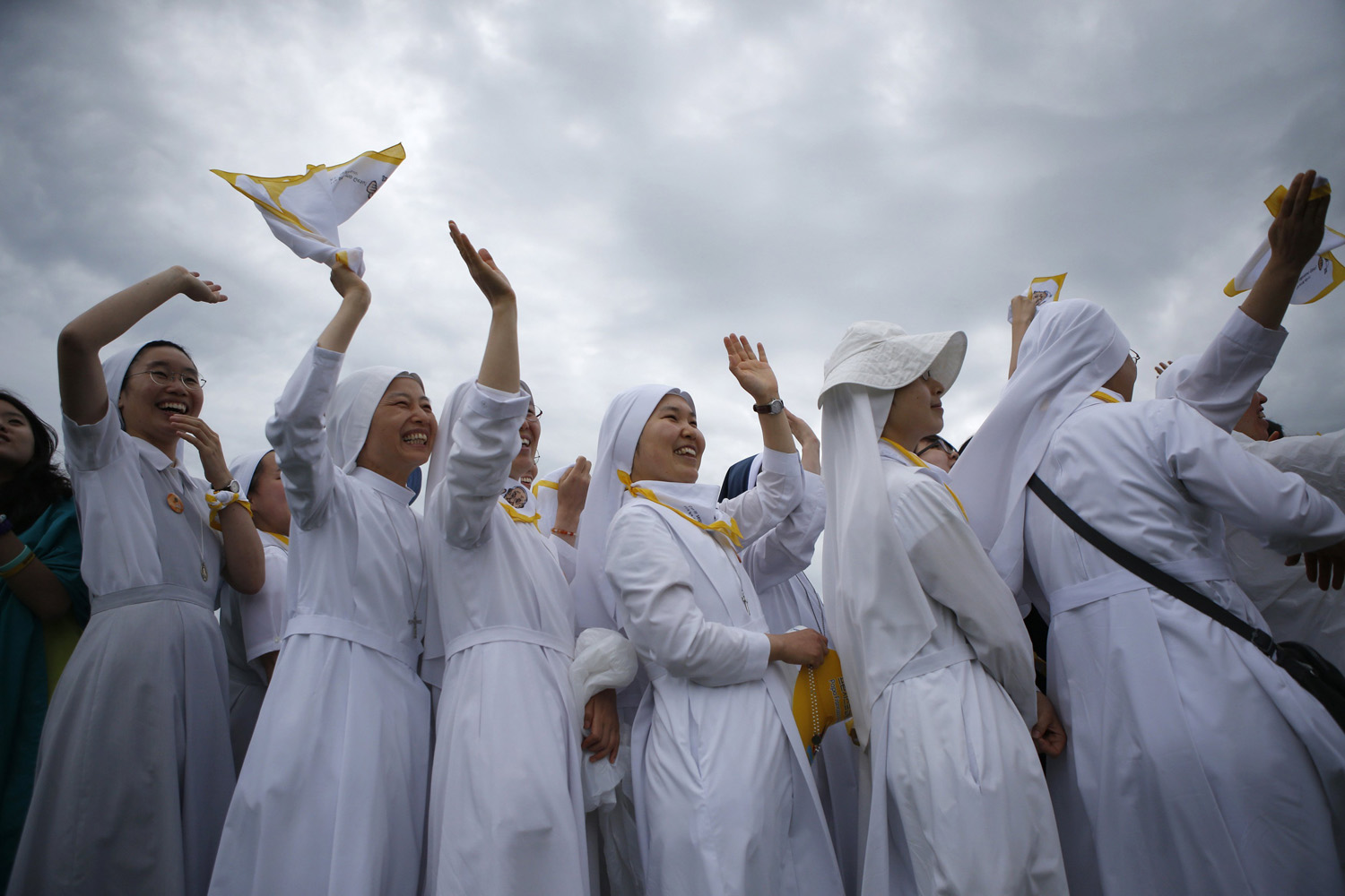 Nuns greet Pope Francis as he arrives for a closing Holy Mass on the 6th Asian Youth Day at Haemi Castle in Haemi, Seoul on Aug. 17, 2014.