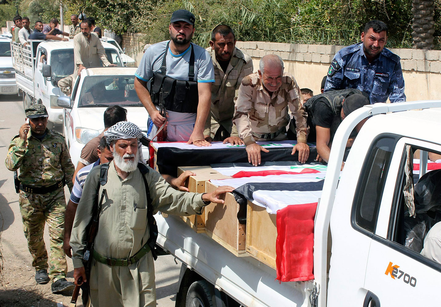 Mourners carry the coffins of Iraqi Shi'ite volunteers, who were killed during clashes with militants of the Islamic State in Amerli. during a funeral in Khalis