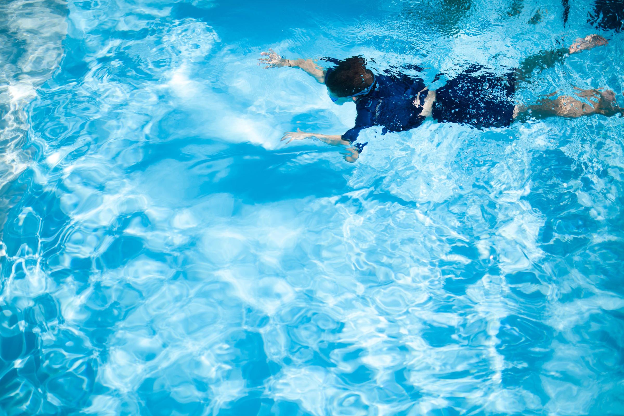 A boy dives in the pool of Kibbutz Be'ery in Israel on Aug. 7, 2014.