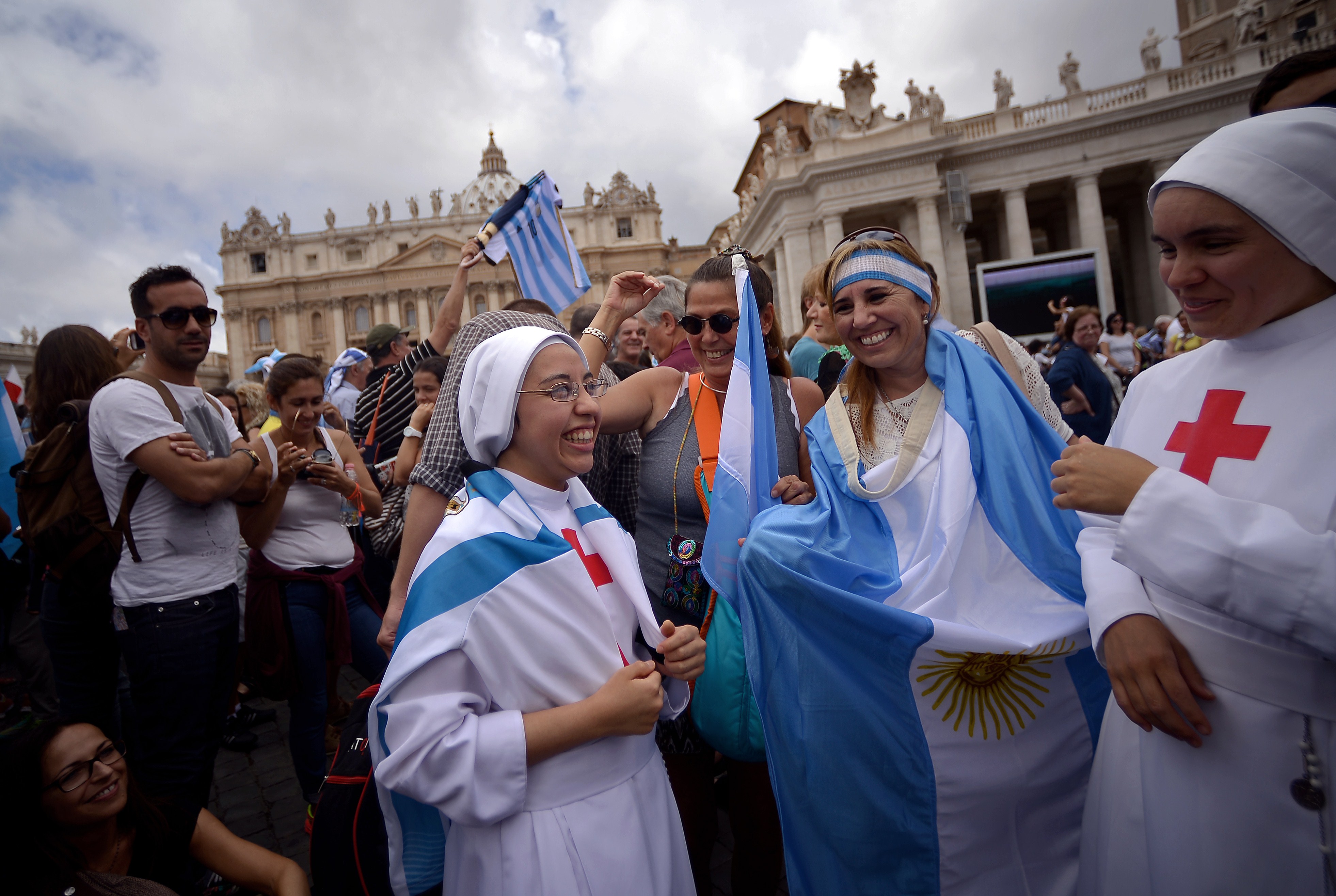 Nuns pose with the jersey of Argentinian football star Lionel Messi and flags prior Pope Francis Sunday Angelus prayer at St. Peter's Square on July 13, 2014 at the Vatican. (FILIPPO MONTEFORTE&mdash;AFP/Getty Images)