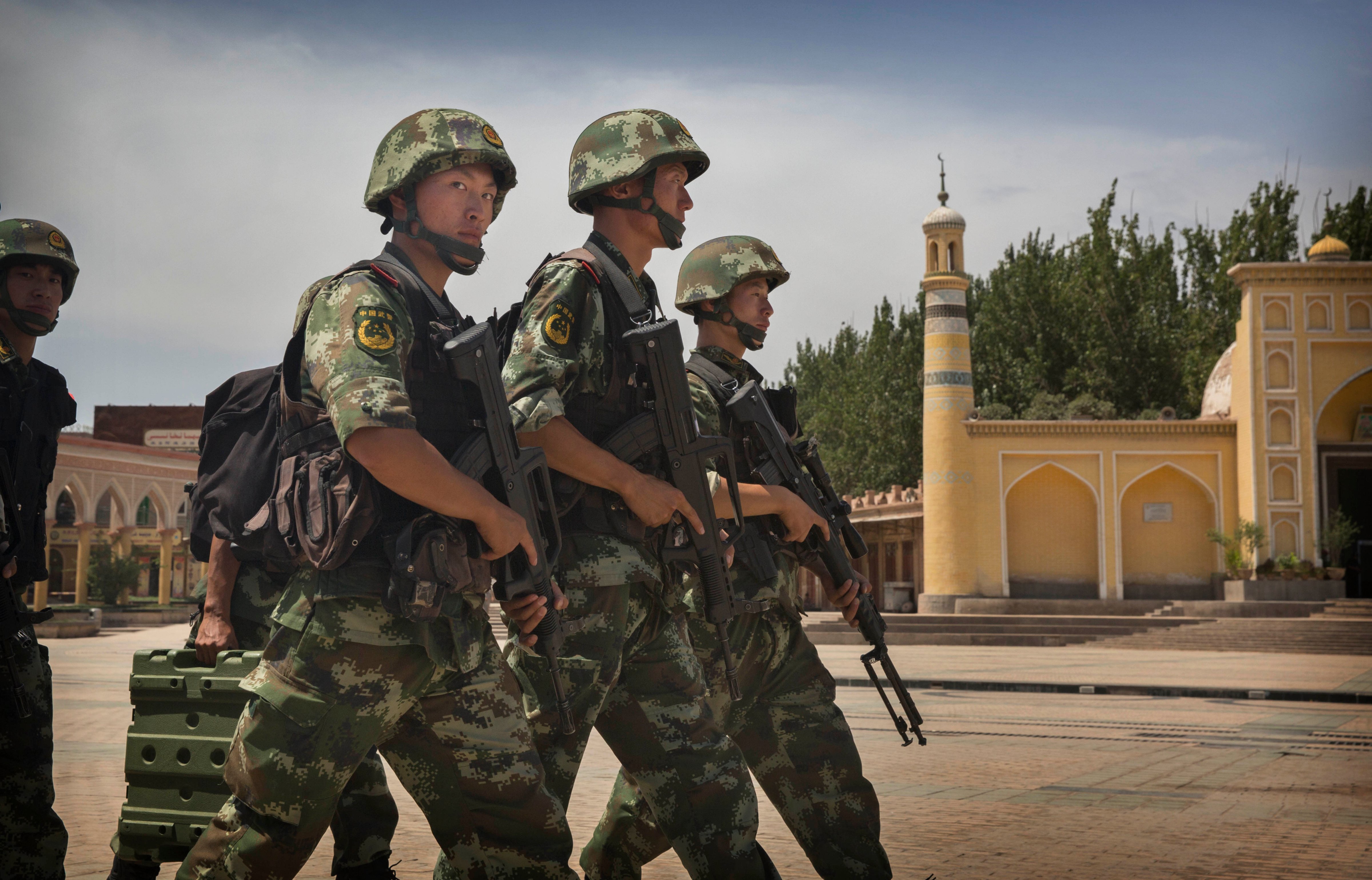 Chinese soldiers march in front of the Id Kah Mosque, China's largest, in Kashgar, on July 31, 2014. China has increased security in many parts of restive Xinjiang  following some of the worst violence in months (Kevin Frayer—Getty Images)