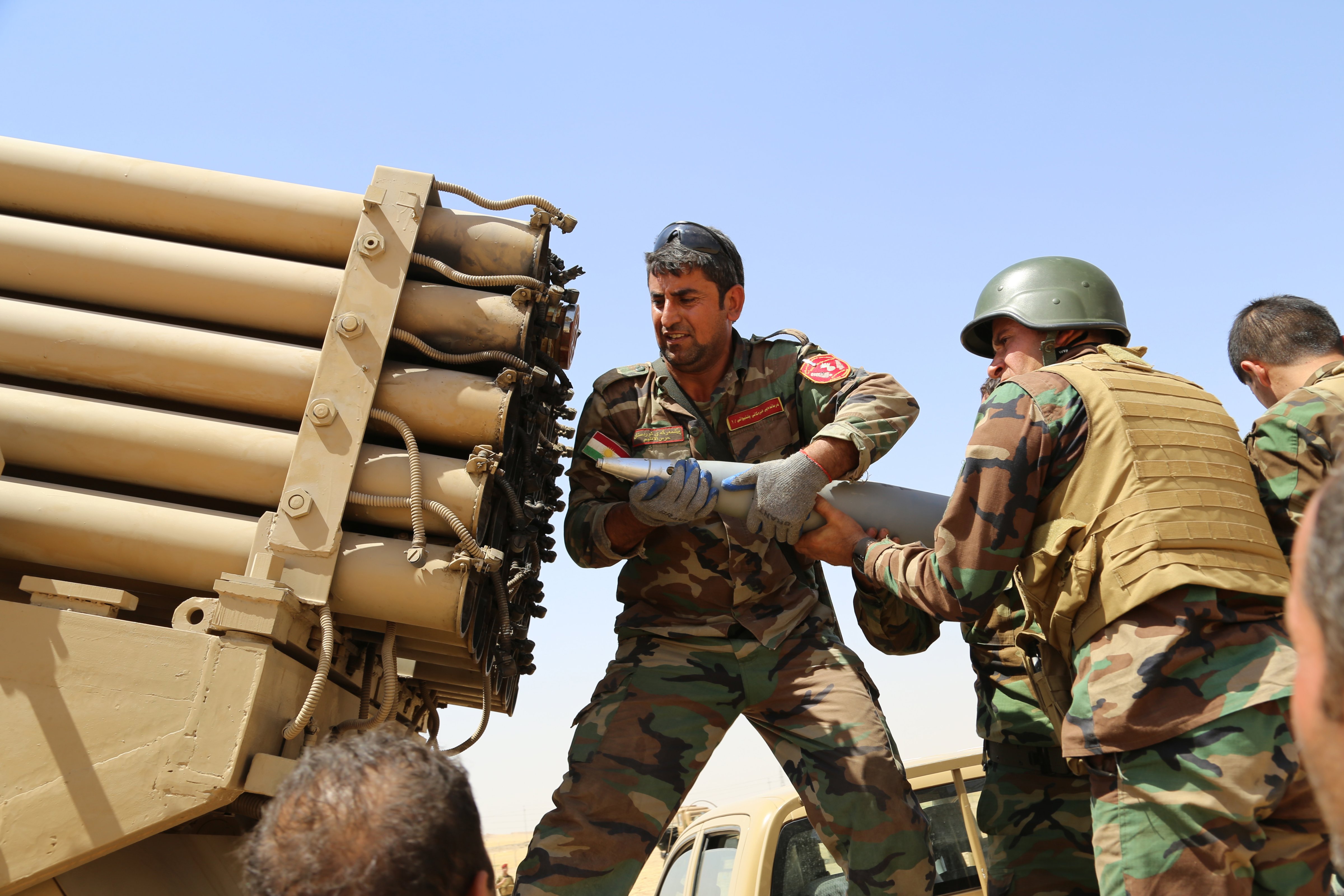 Kurdish peshmerga fighters load missile launcher during the clashes with the army groups led by Islamic State of Iraq and the Levant (ISIL) in Mosul, Iraq on 8 August, 2014. (Anadolu Agency&mdash;Getty Images)