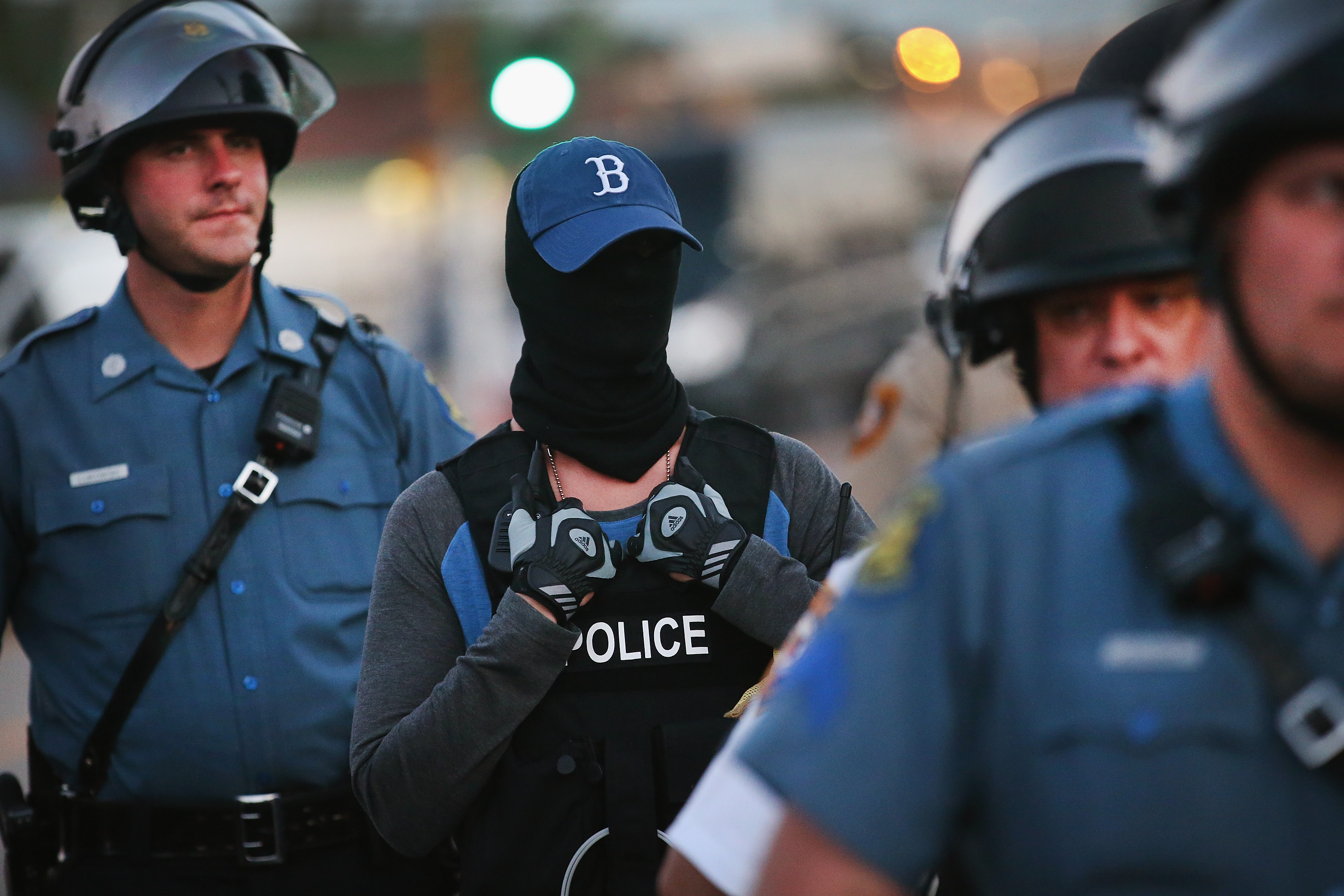A police officer standing watch as demonstrators protest the shooting death of teenager Michael Brown conceals his/her identity on August 13, 2014 in Ferguson, Missouri. (Scott Olson&mdash;Getty Images)