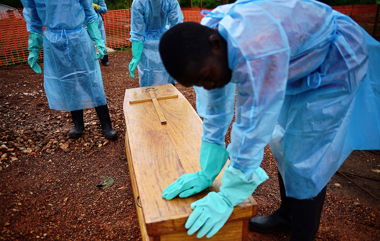 A Sierra Leone government burial team with the coffin of Dr Modupeh Cole, Sierra Leone's second senior physician to die of Ebola, at the MSF facility in Kailahun, Sierra Leone, on Aug. 14, 2014. (Carl De Souza—AFP/Getty Images)