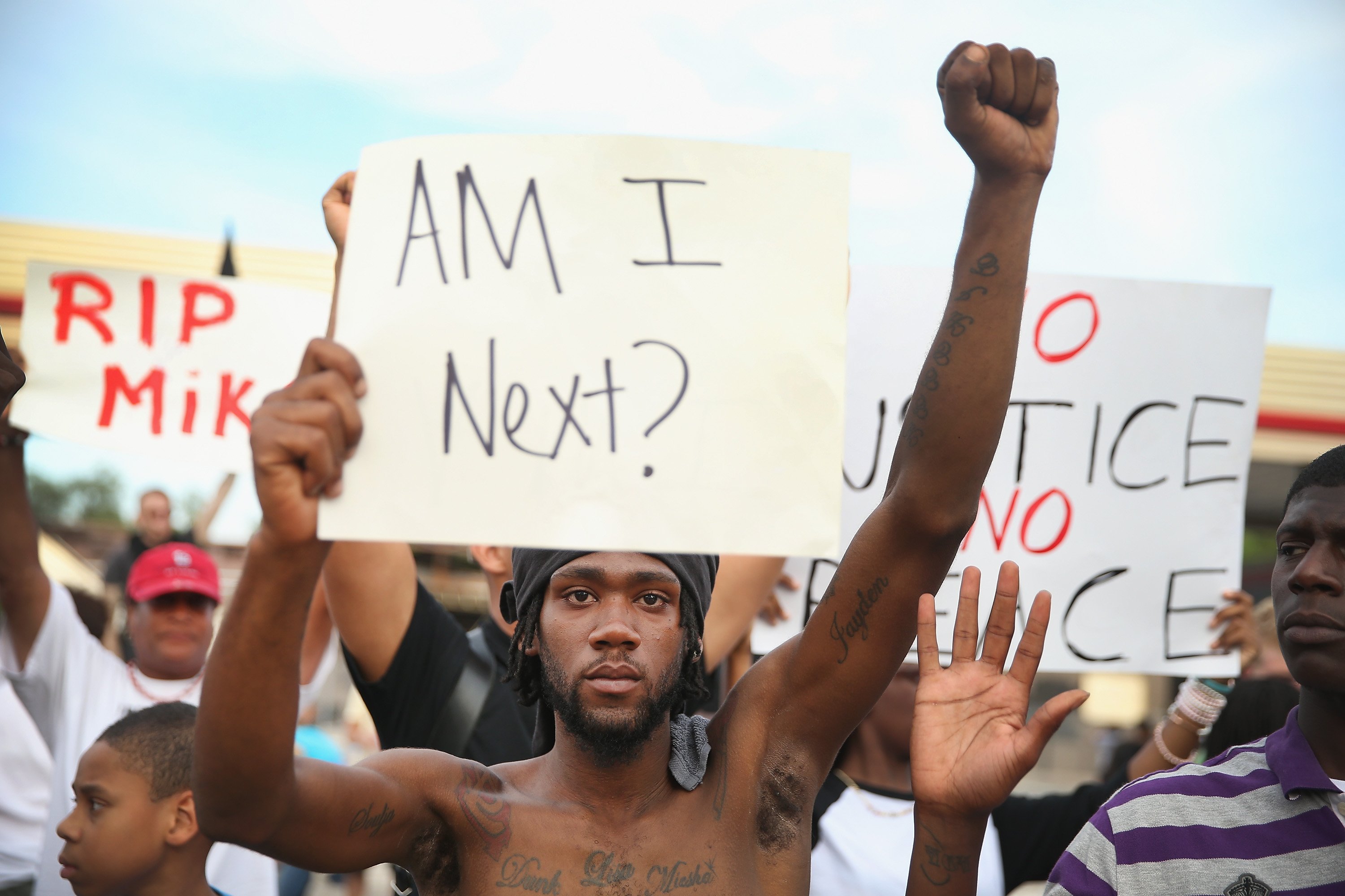 Demetrus Washington joins other demonstrators protesting the shooting death of teenager Michael Brown in Ferguson, Mo. on Aug. 14, 2014.