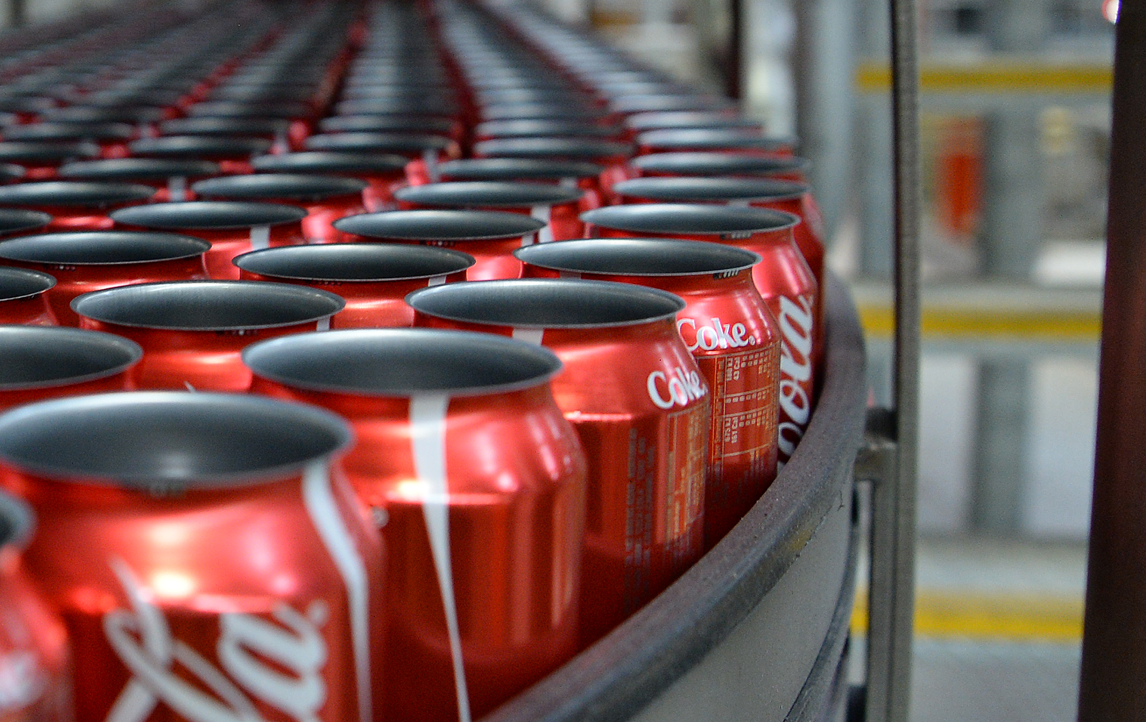 Empty Coca-Cola Classic cans move along a conveyor to be filled. (Bloomberg&mdash;Bloomberg via Getty Images)