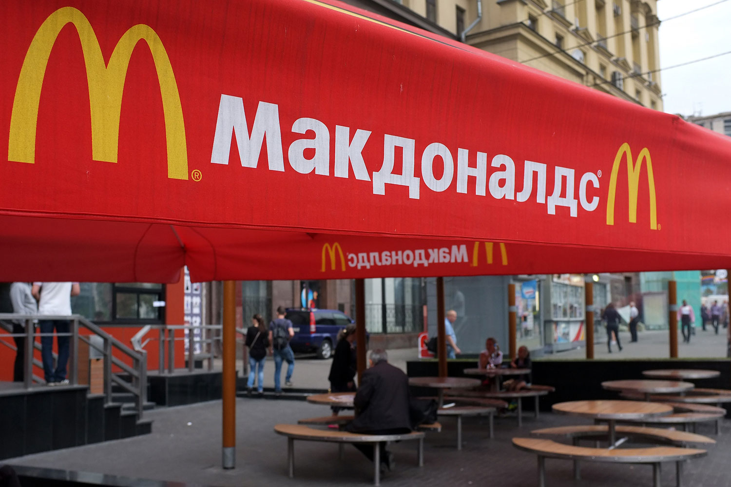 People sit on the terrace of a closed McDonald's restaurant, the first to be opened in the Soviet Union in 1990, in Moscow on Aug. 21, 2014. (Alexander Nemenov—AFP/Getty Images)