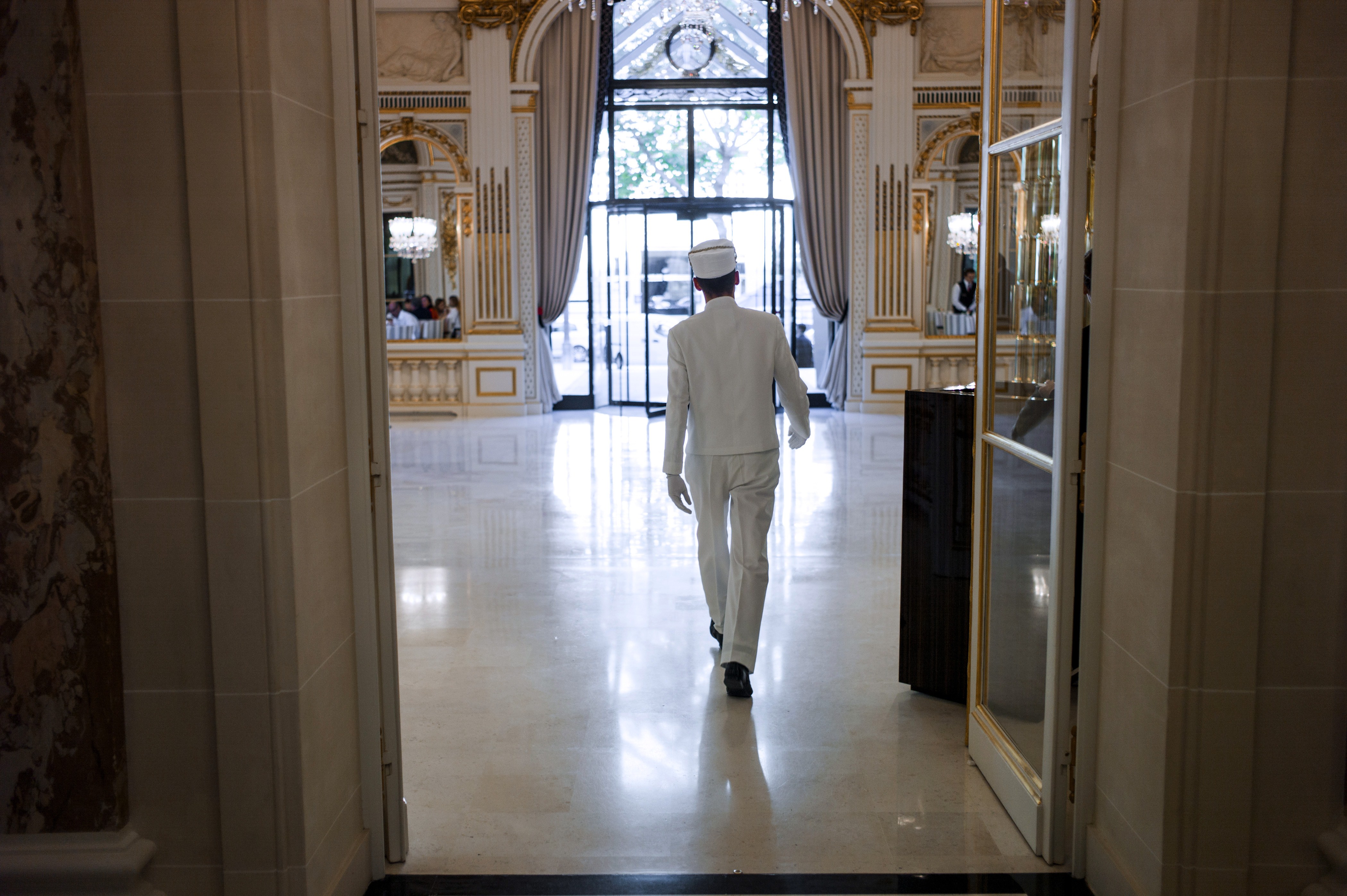 A bellhop walks at the entrance of the "The Peninsula Paris" hotel on August 21, 2014 in Paris. (Fred Dufour—AFP/Getty Images)