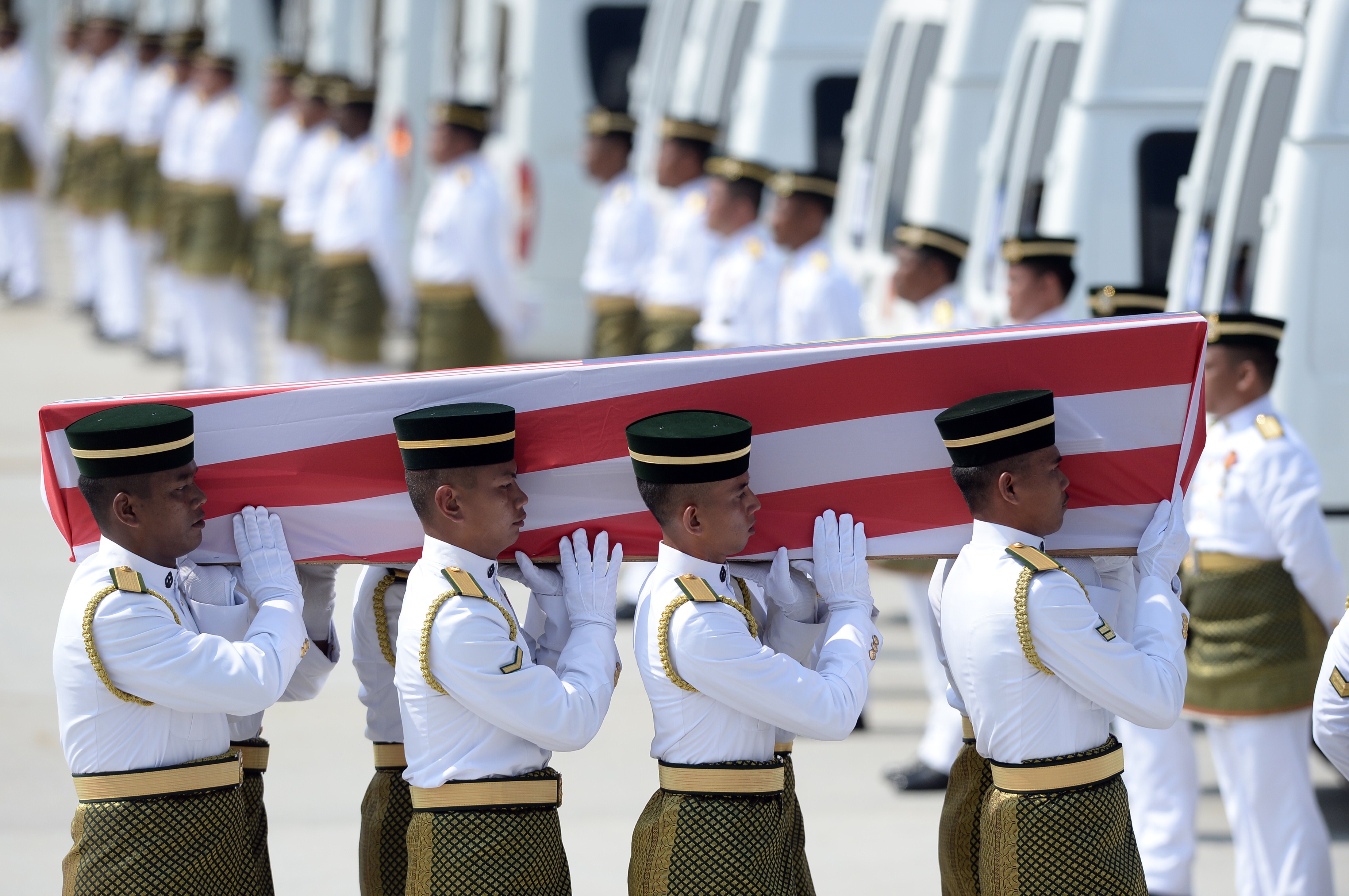Soldiers carry a coffin with the remains of a Malaysian victim from Malaysia Airlines Flight 17, which crashed in Ukraine, during a ceremony at Kuala Lumpur International Airport on Aug. 22, 2014 (Manan Vatsyayana—AFP/Getty Images)
